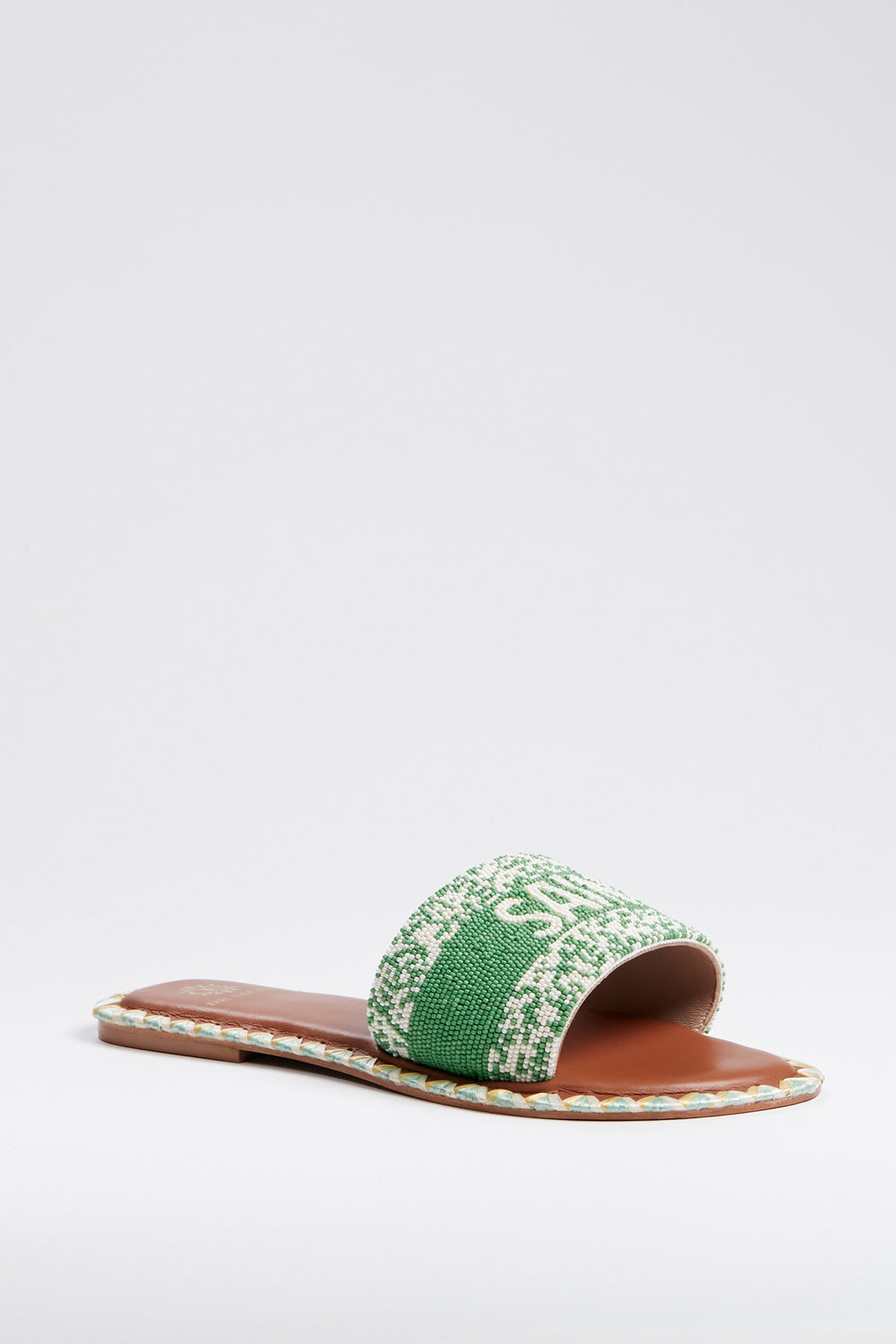 De Siena's handcrafted women's flat slide sandal features a brown sole and a green-and-white woven upper strap, celebrating sustainable fashion.