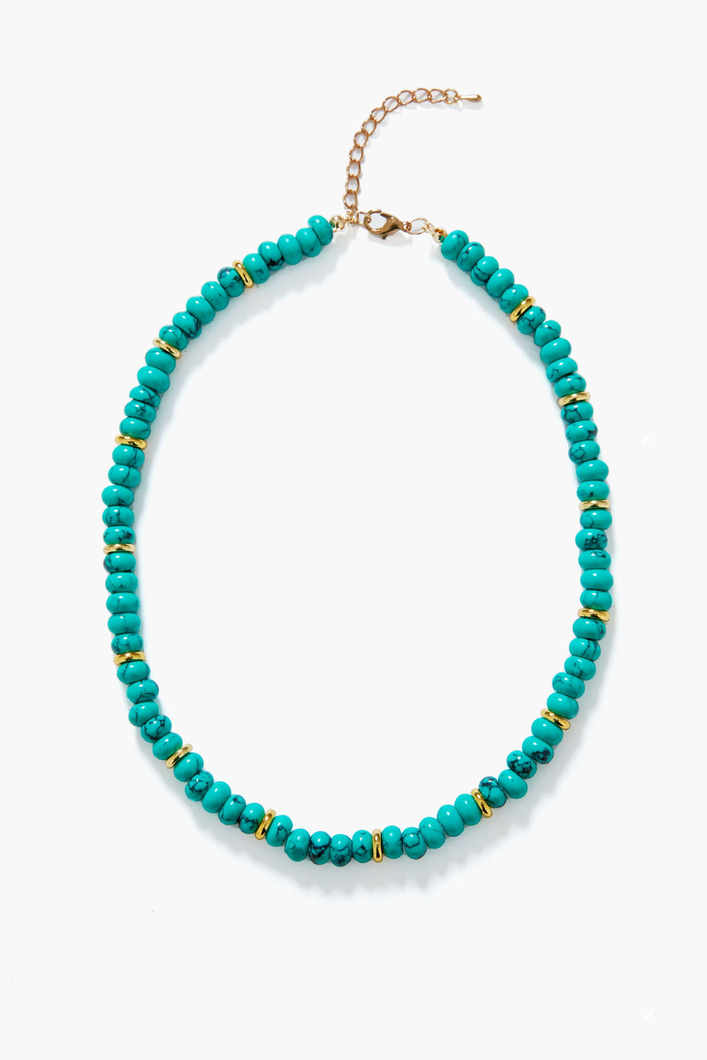 The Elfie Necklace by Petit Moments features turquoise beads, small gold spacers, and a gold clasp—capturing classic resort jewelry style.
