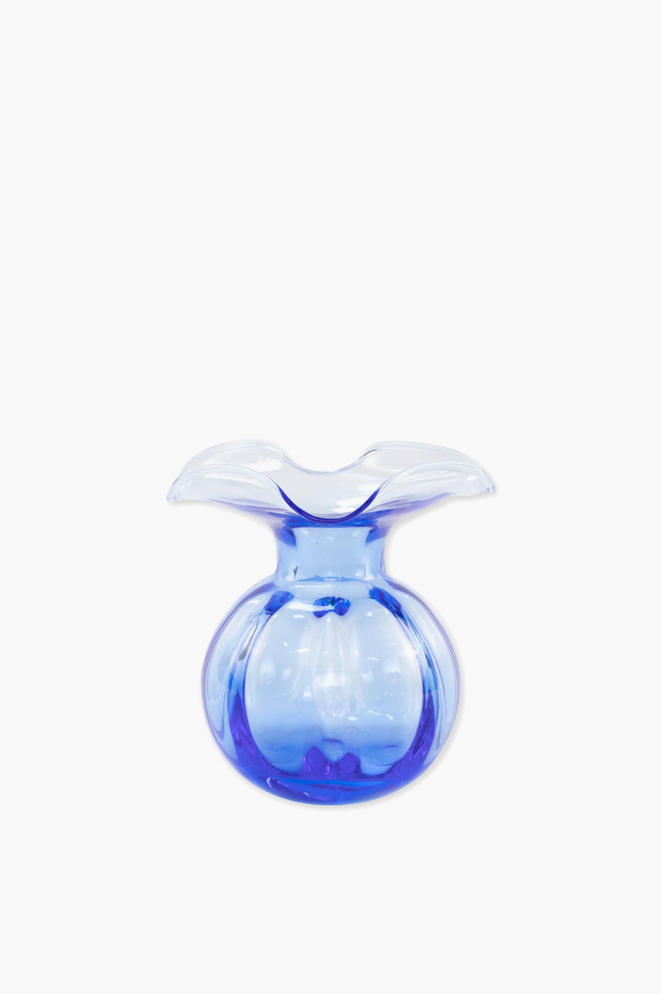 The Vietri Hibiscus Glass Cobalt Blue Bud Vase is small, clear, and blue with a wide flared rim and rounded body, handmade in Italy.