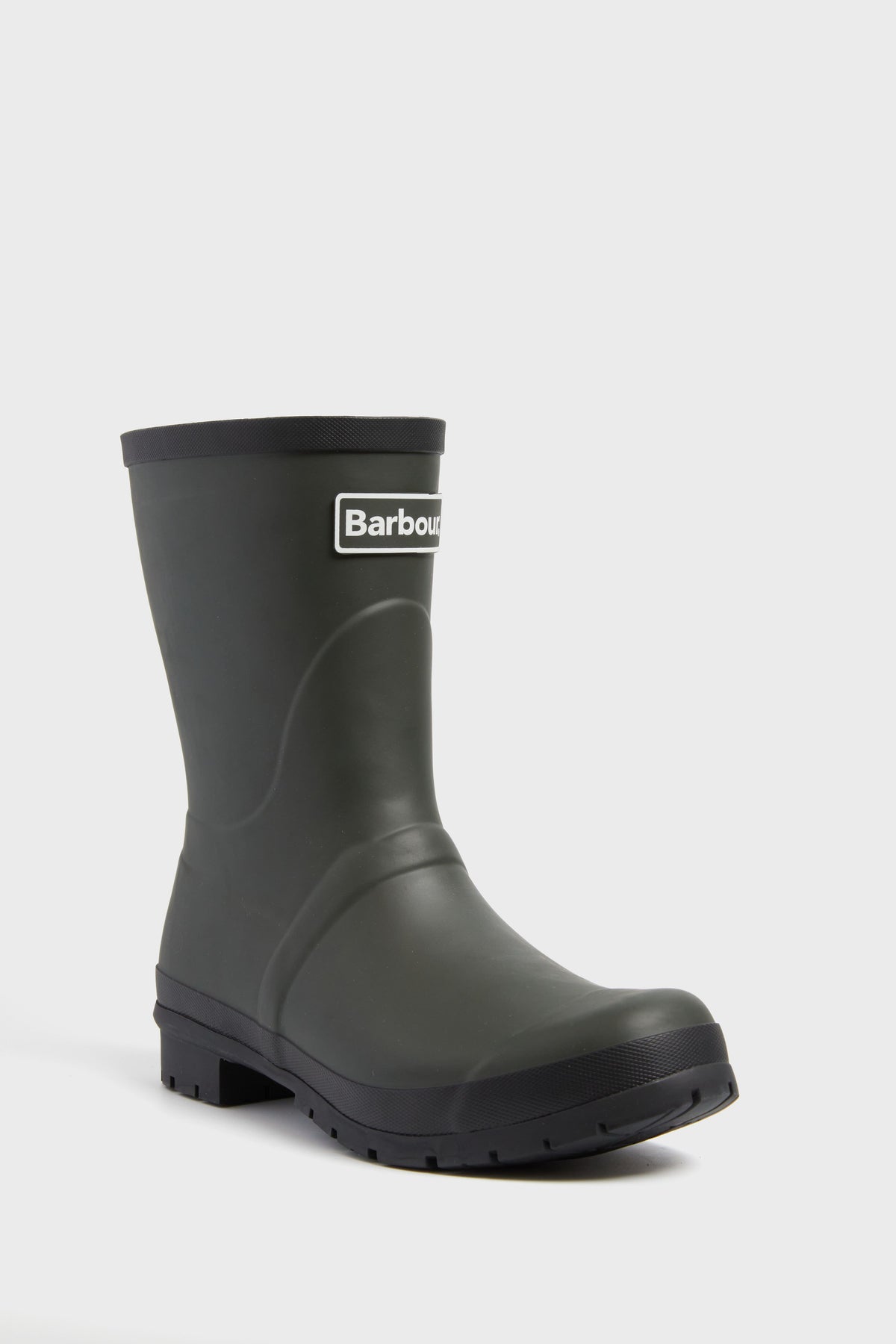 A single black Barbour wellington boot with a chunky sole and the Barbour logo on the front, ideal as waterproof outdoor footwear.