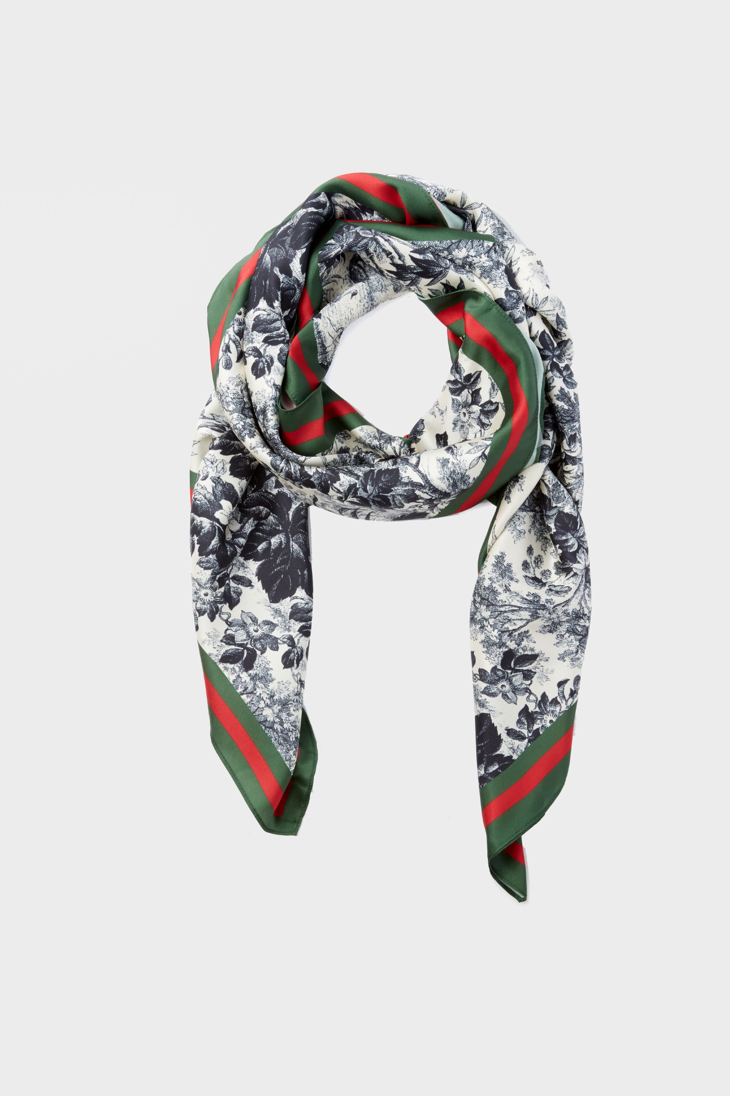 The Tuckernuck Accessories Silk Cypress Toile Scarf features a timeless black and white floral print with striking green and red striped borders, making it an elegant classic accessory.