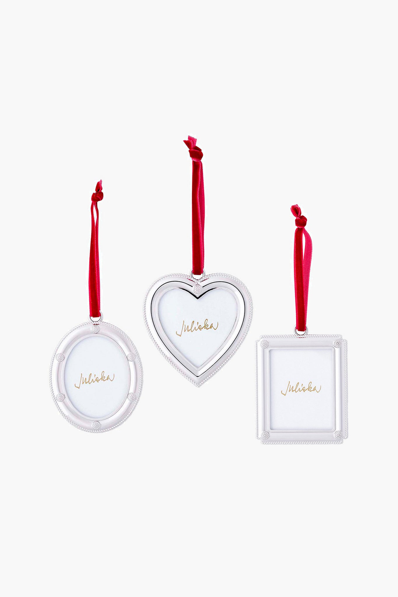 Three Juliska silver picture-frame ornaments—round, heart-shaped, and square—hang from red ribbons, ideal for festive holiday décor or as a thoughtful hostess gift.