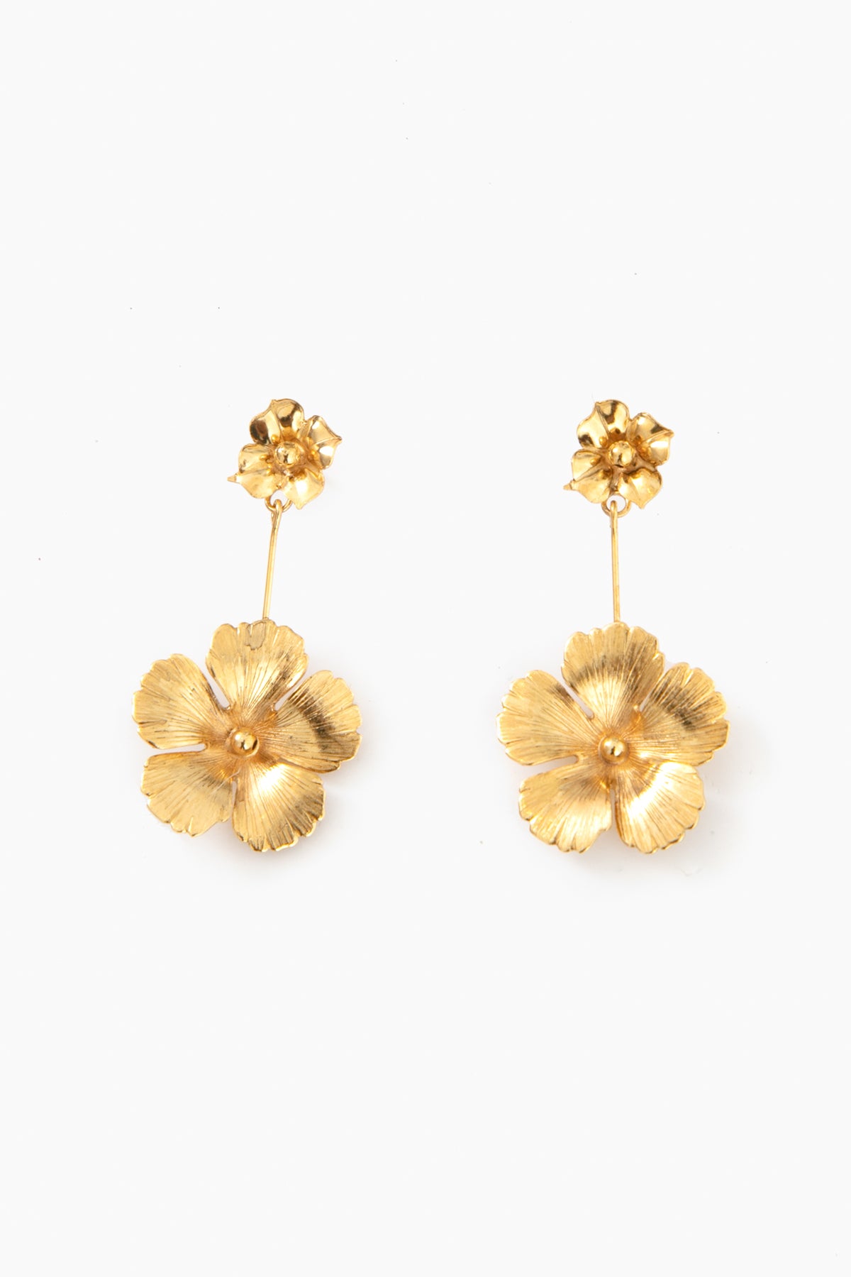 Jennifer Behr's luxury gold floral earrings are handmade in New York, featuring a small flower at the post and a larger flower dangling below.