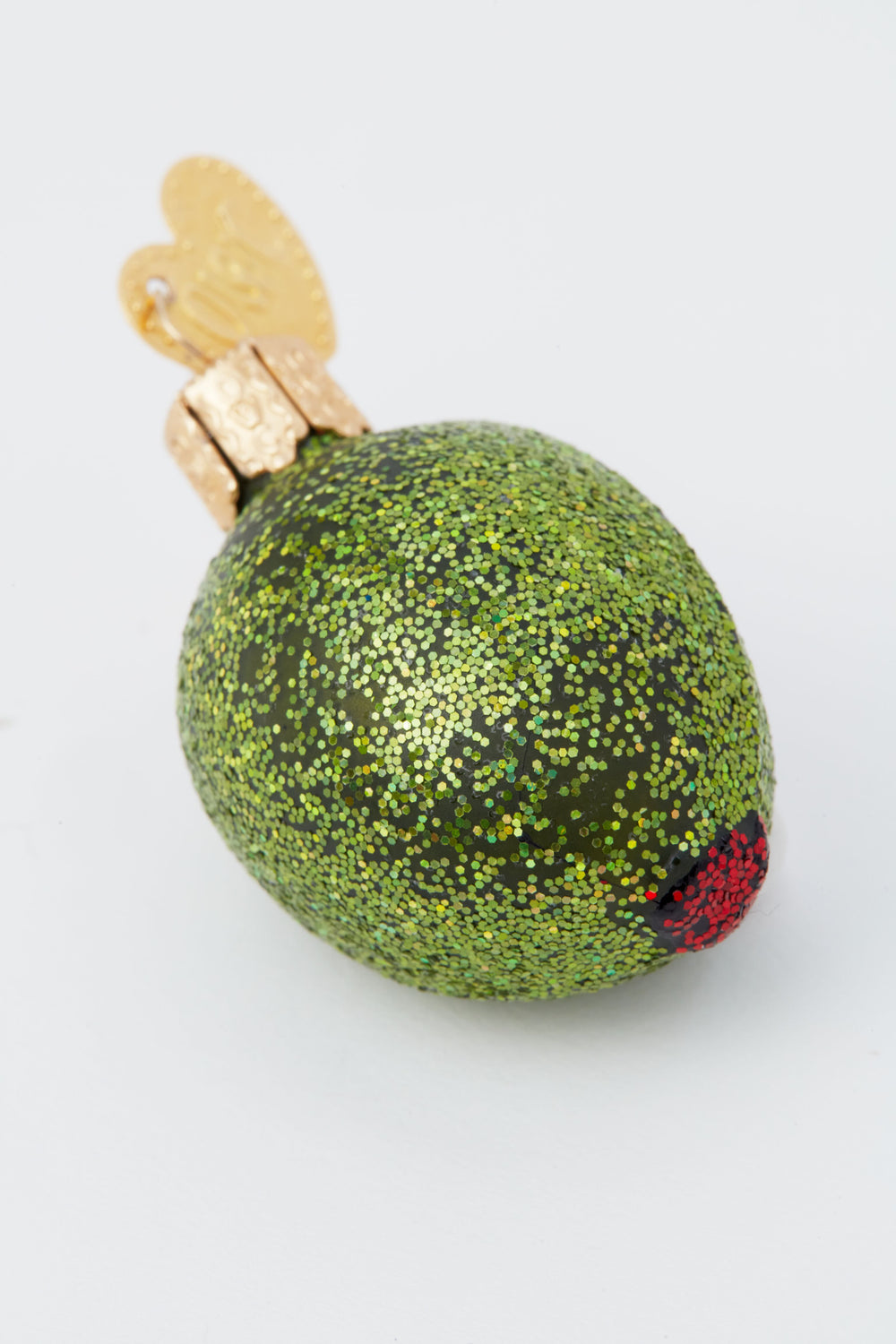 Old World Christmas glass-blown green olive ornament features a glittery finish, red pimento, and gold cap—perfect for any dirty martini fan’s holiday décor.