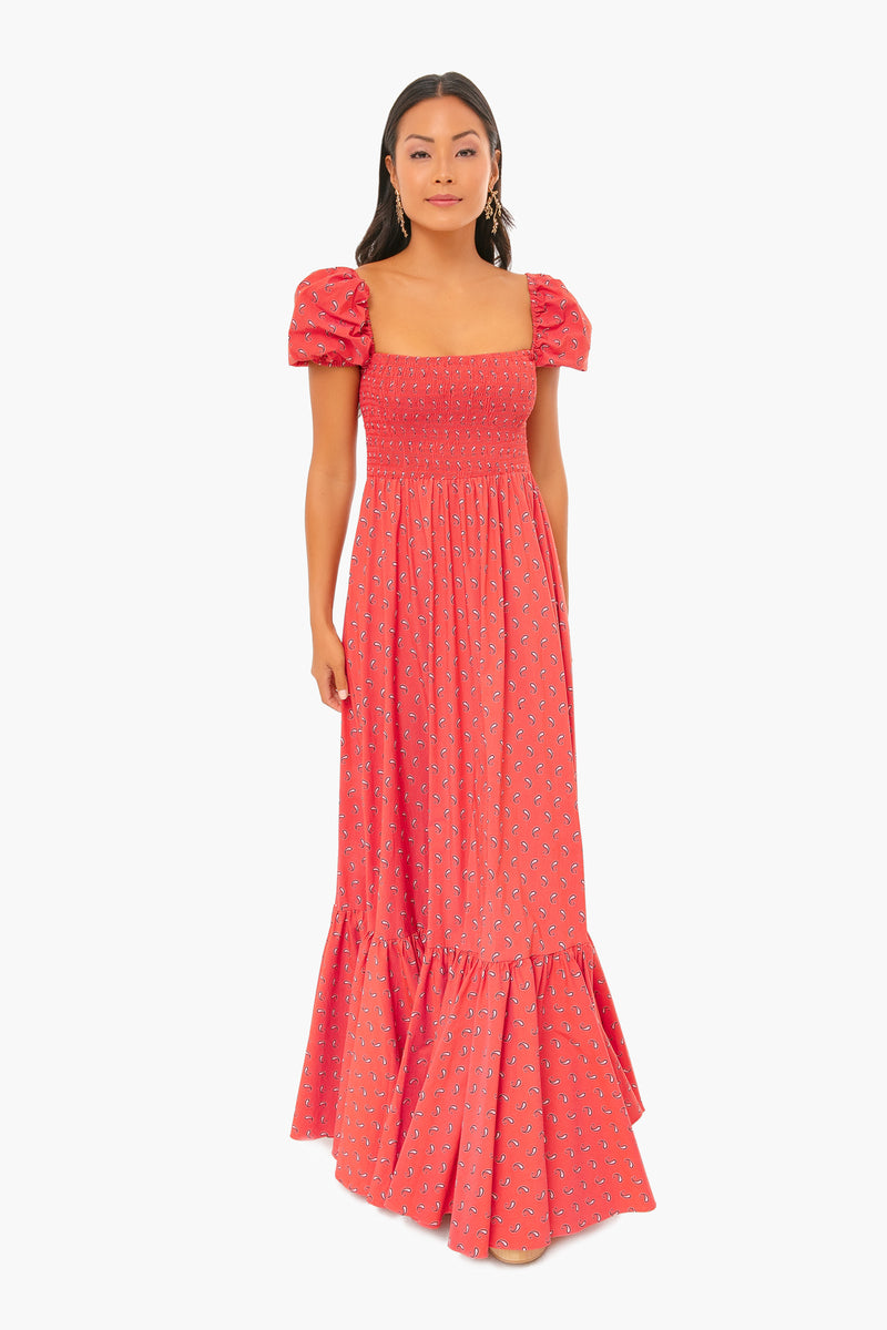 A woman stands confidently facing forward in a Caroline Constas red floral-print Gianna Dress, featuring short puff sleeves and a square neckline.