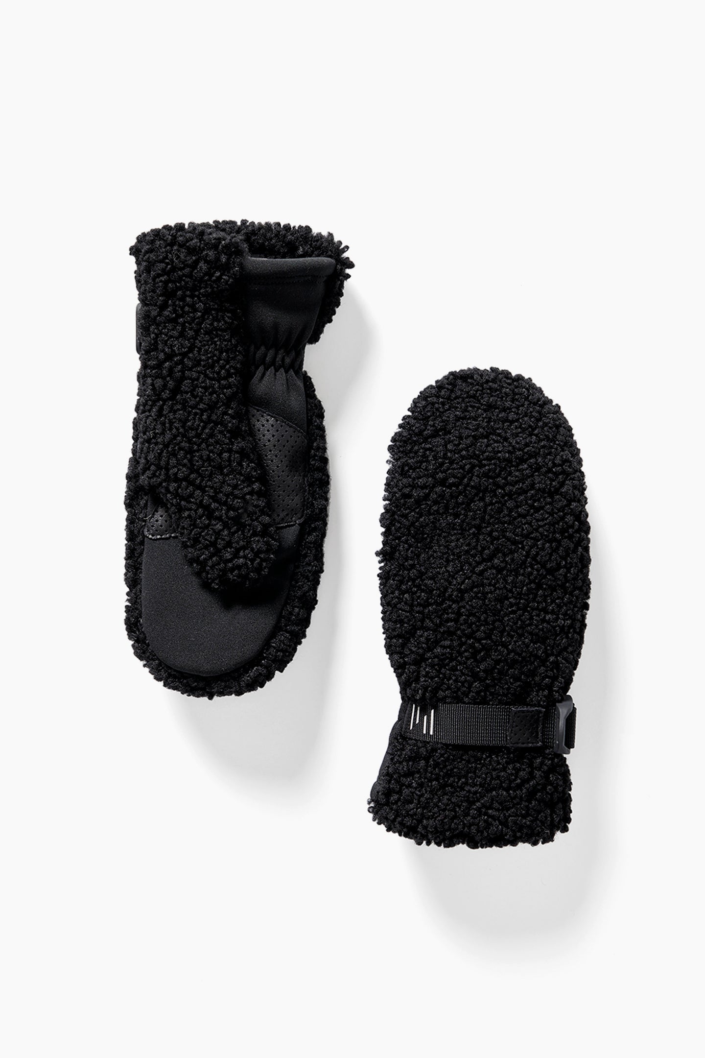A pair of Holden Sherpa mittens featuring black fleece and a textured, fluffy exterior; one mitten reveals the faux fur lining on the palm, while the other shows the back.