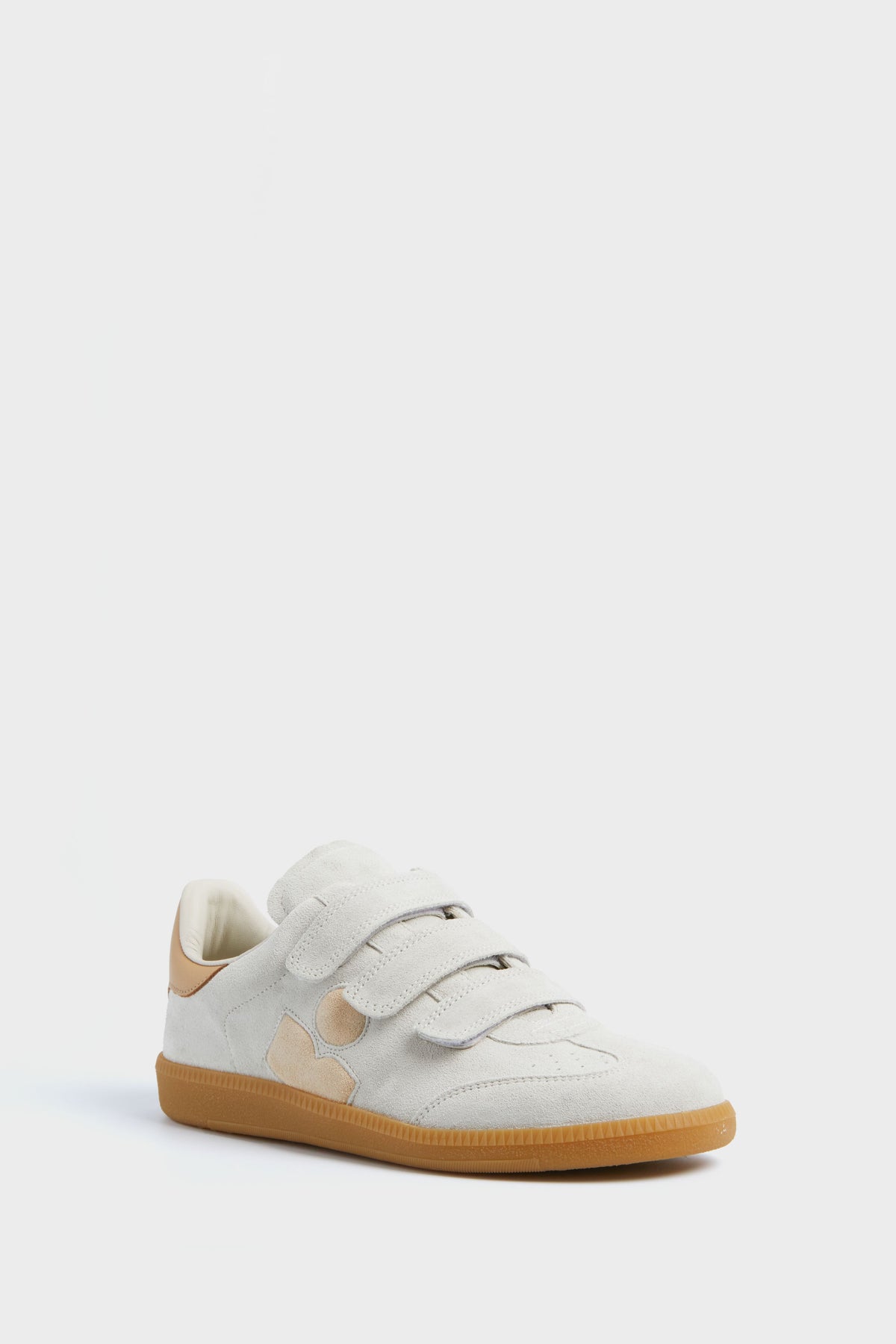 The Isabel Marant Chalk Beige Beth Classic Sneakers feature light beige suede leather, three velcro straps, tan accents, a gum rubber sole, and the brand's iconic sneaker style.