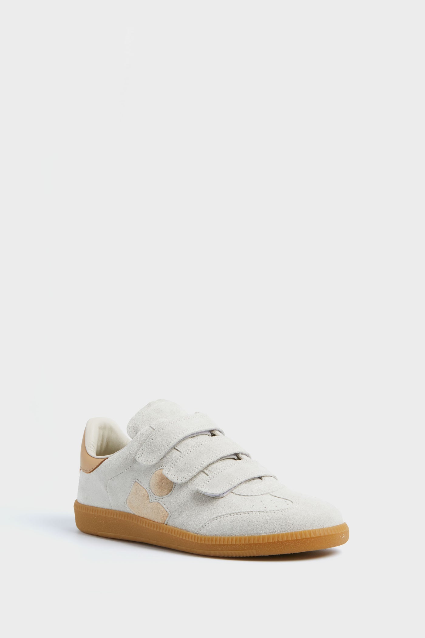 The Isabel Marant Chalk Beige Beth Classic Sneakers feature light beige suede leather, three velcro straps, tan accents, a gum rubber sole, and the brand's iconic sneaker style.
