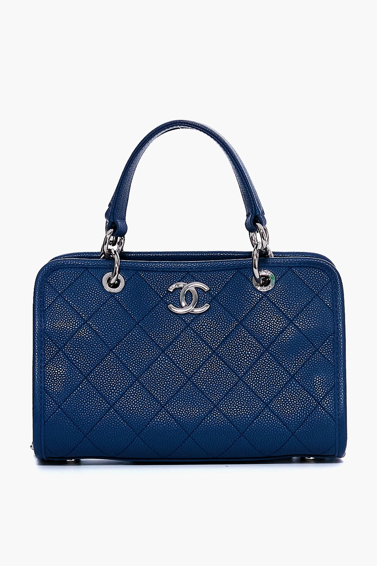 A Tuckernuck Archive Collection blue quilted leather shopping tote with silver hardware, two handles, and a bold logo on the front.