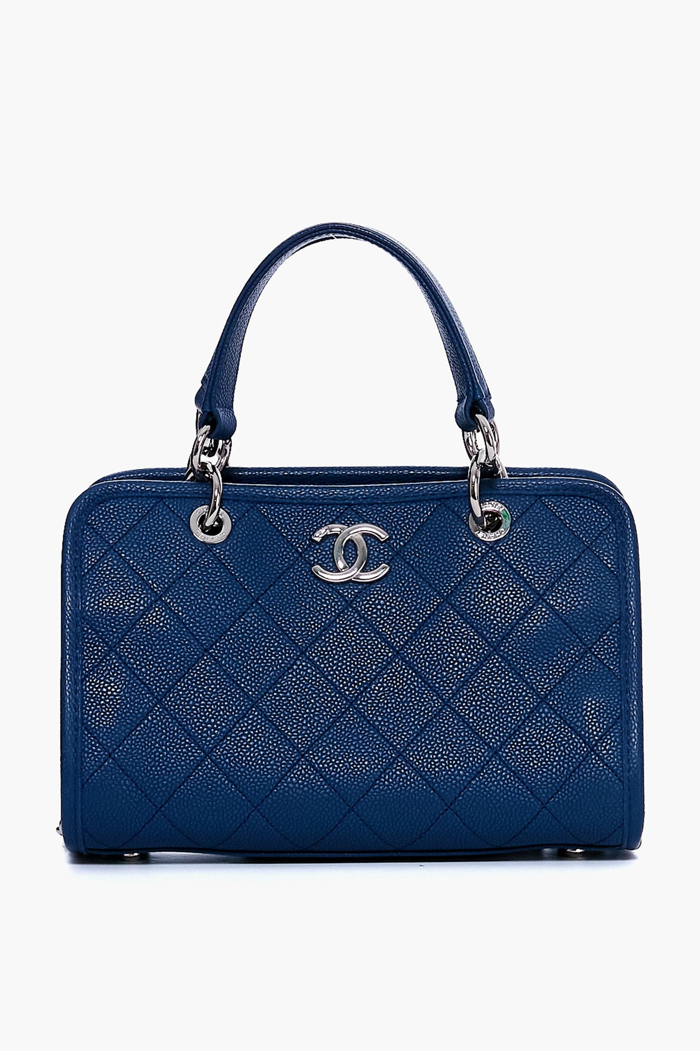 A Tuckernuck Archive Collection blue quilted leather shopping tote with silver hardware, two handles, and a bold logo on the front.