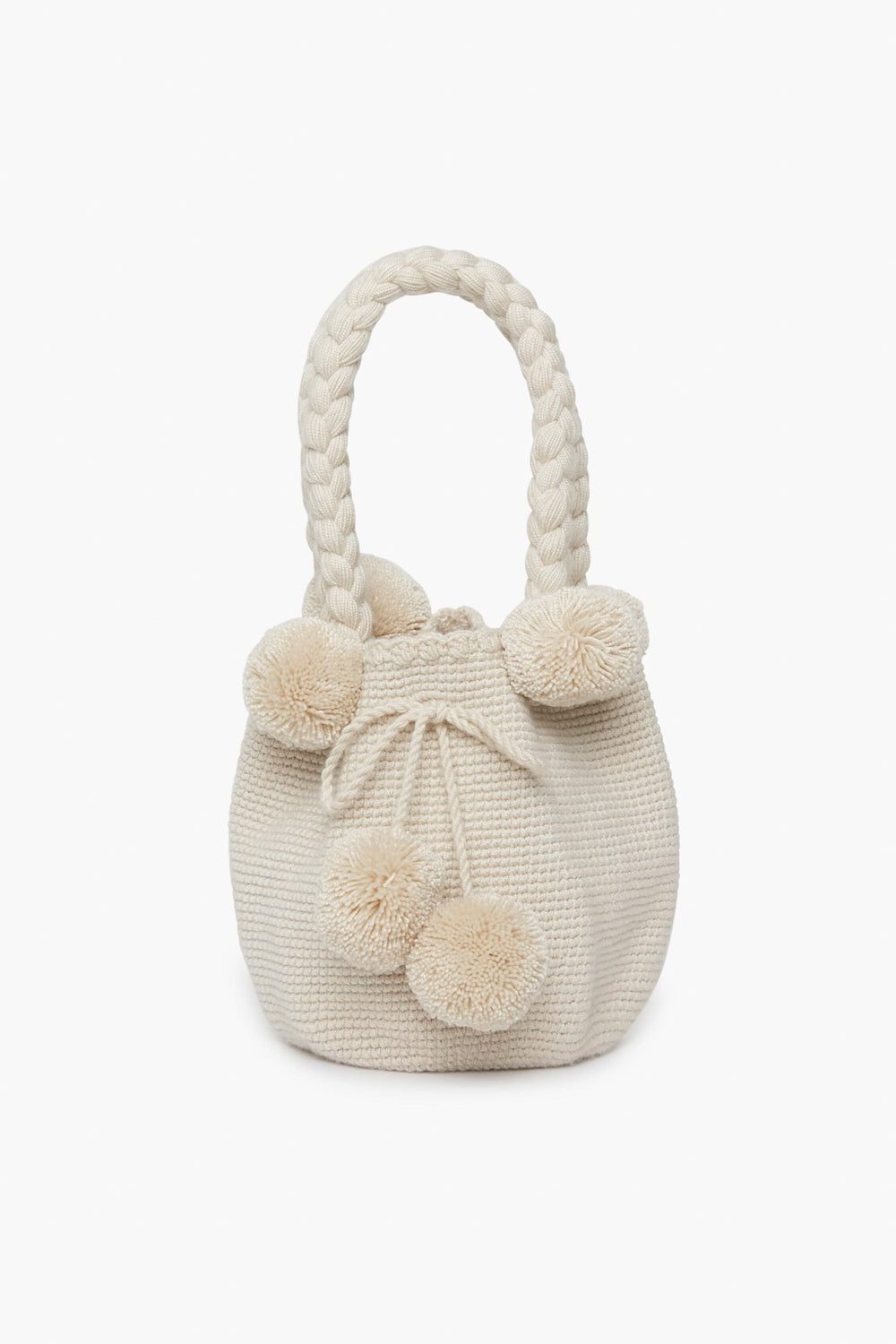 A cream-colored handwoven bag by Marina Orth Foundation from San Jacinto, Colombia, featuring braided handles and decorative pom-poms.