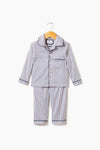 Petite Plume’s children’s navy French ticking pajama set, with long sleeves and pants, is made from cotton for cozy comfort. Shown on a wooden hanger, these pajamas offer soft sleepwear perfect for kids' restful nights.