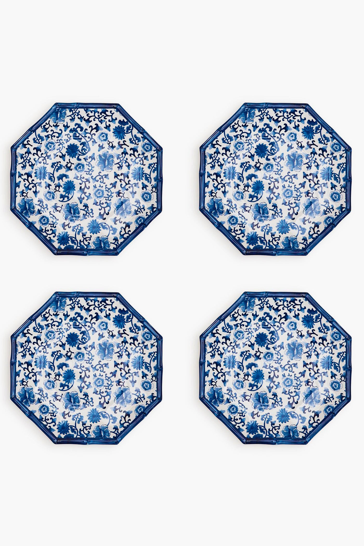 Four octagon-shaped melamine plates by Two's Company feature blue and white floral patterns, arranged in a two-by-two grid. These shatter-resistant plates add both elegance and durability to your table setting.