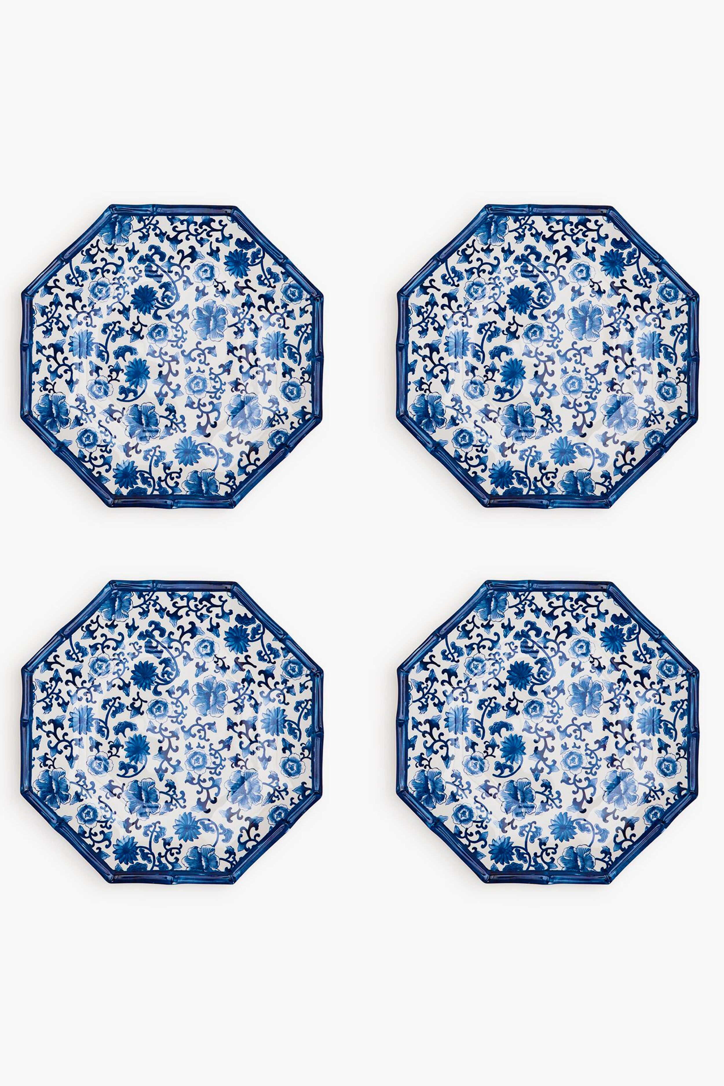 Four octagon-shaped melamine plates by Two's Company feature blue and white floral patterns, arranged in a two-by-two grid. These shatter-resistant plates add both elegance and durability to your table setting.