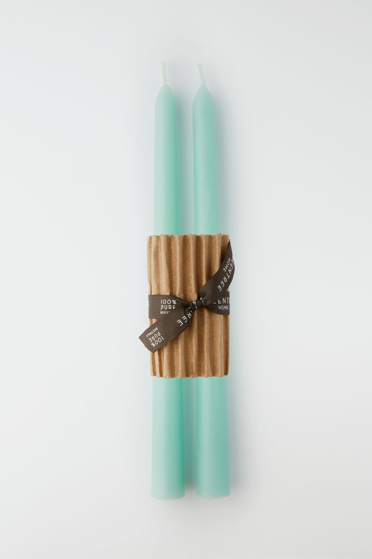 Two Greentree Home Robins Egg Blue hand-poured candles are bundled together with a corrugated cardboard sleeve and finished with a brown ribbon.