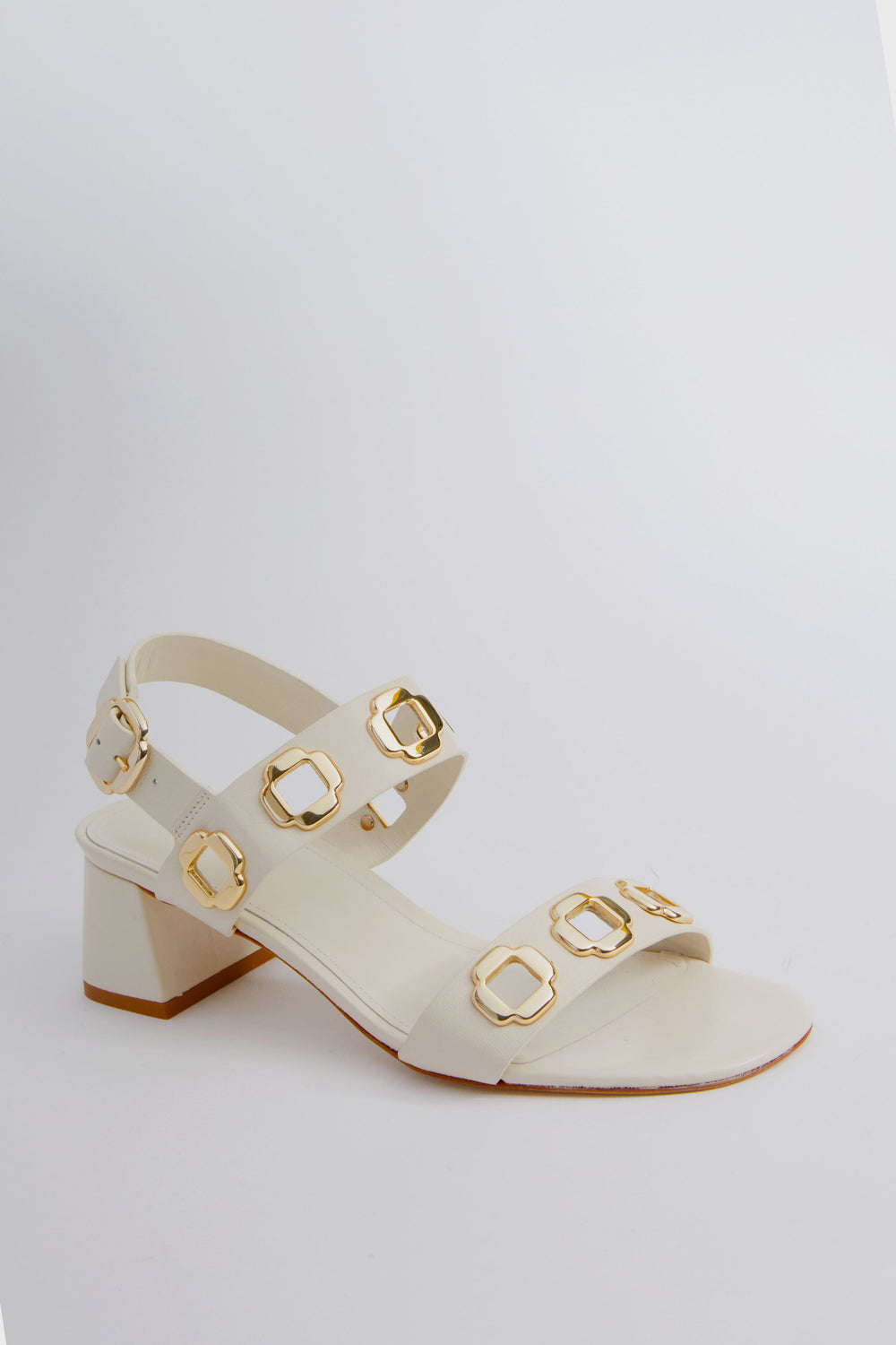 Larroude ivory leather sandals with two straps featuring gold square buckles, set on a low white block heel.