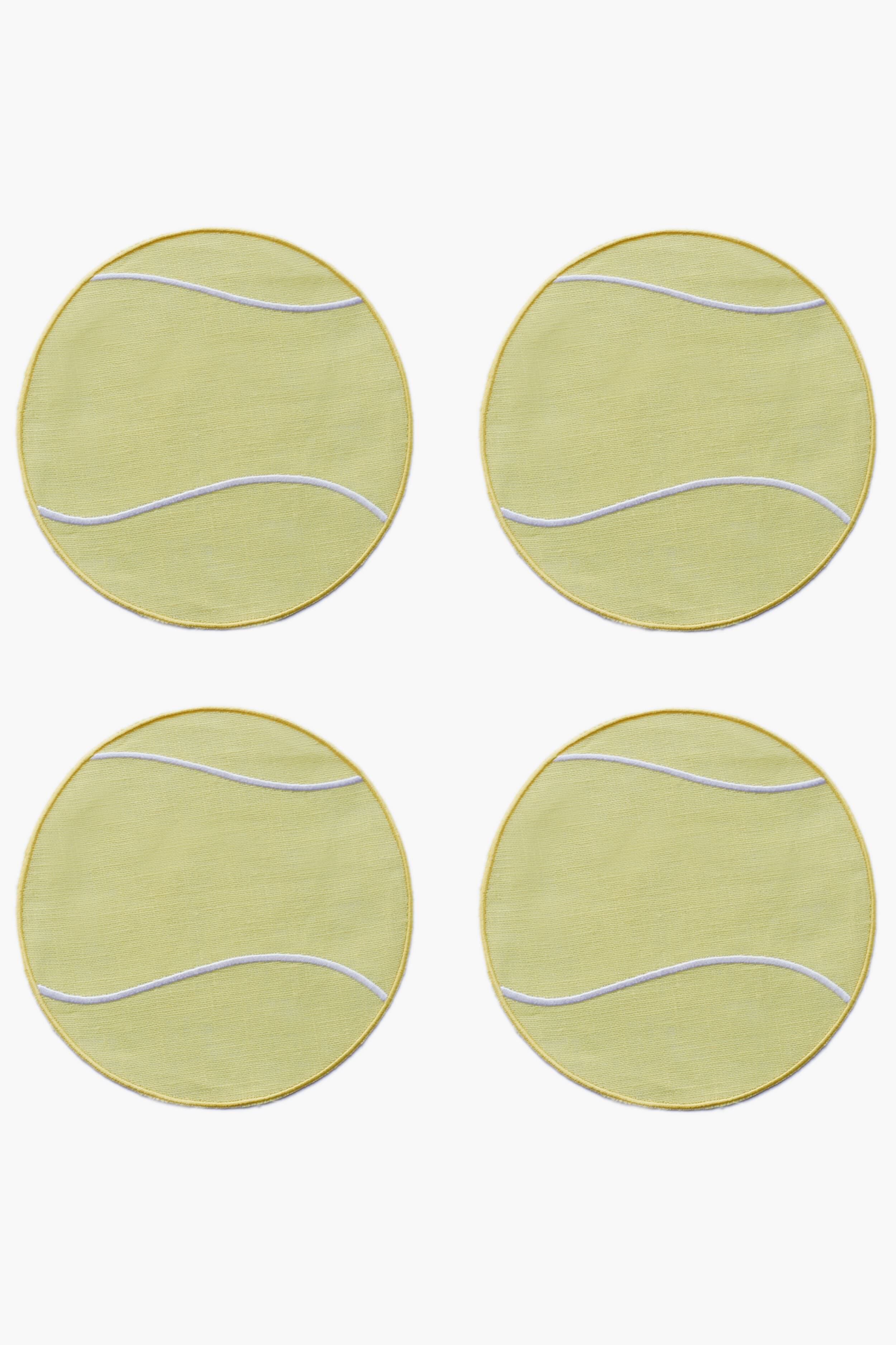 Four round yellow coasters with white curved lines, arranged in a square grid—resembling Tennis Ball Cocktail Napkins by Chefanie, perfect as a racket sport gift.