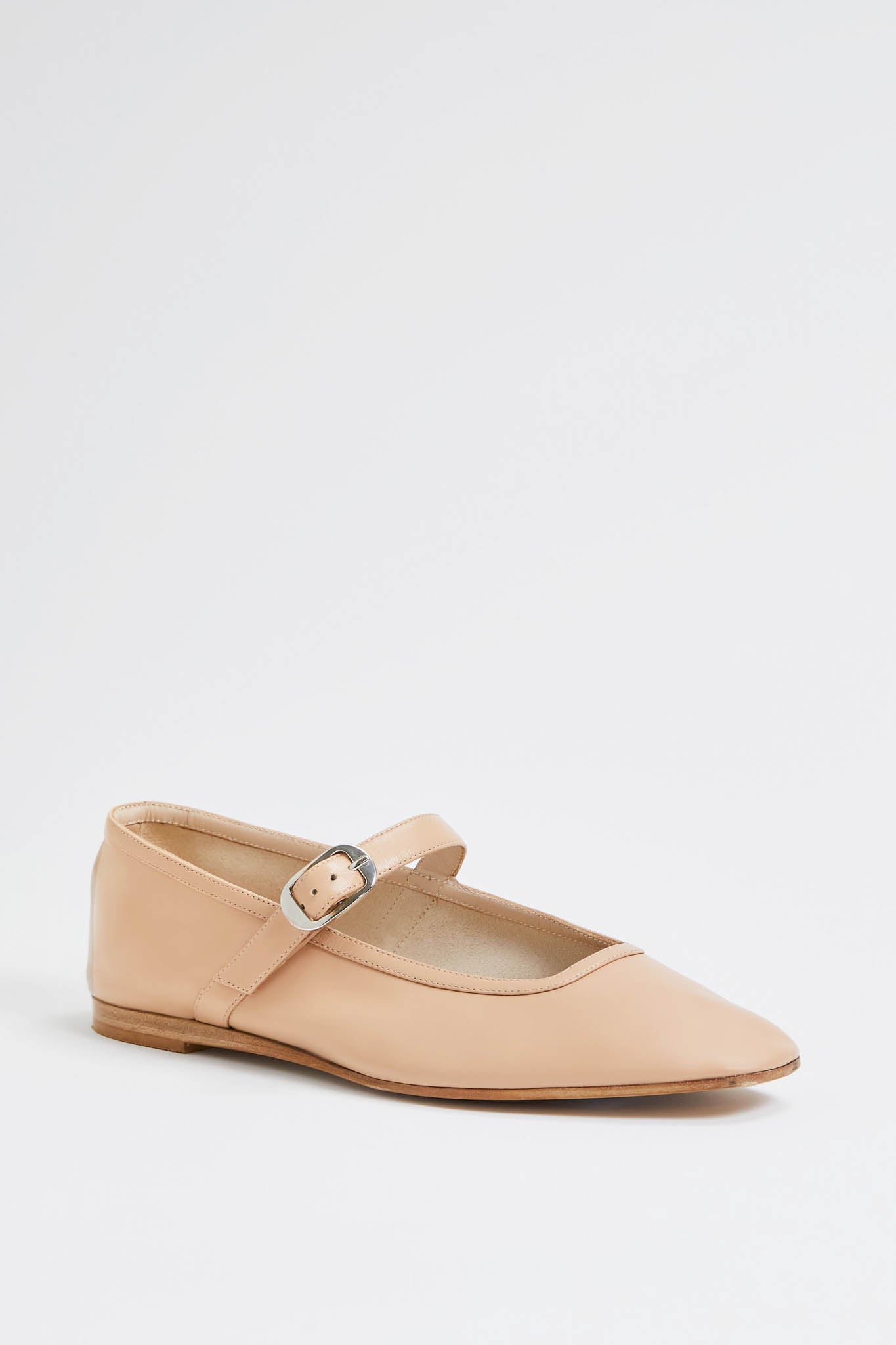 A beige Mary Jane flat by Le Monde Beryl, featuring a silver buckle strap and crafted in lambskin ballet flat style.