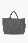 The Naghedi tote is a large, gray woven neoprene bag with two short handles, combining style and versatility for everyday use.