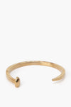 A gold Railroad Spike Bracelet by Giles and Brother, designed with a rounded tip on one end and a flat end on the other.