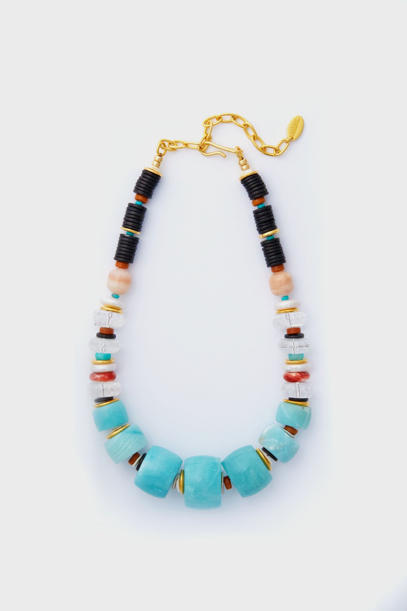 The Lizzie Fortunato statement necklace features large turquoise beads with smaller black, white, orange, and gold accents, all finished with a gold adjustable chain clasp.