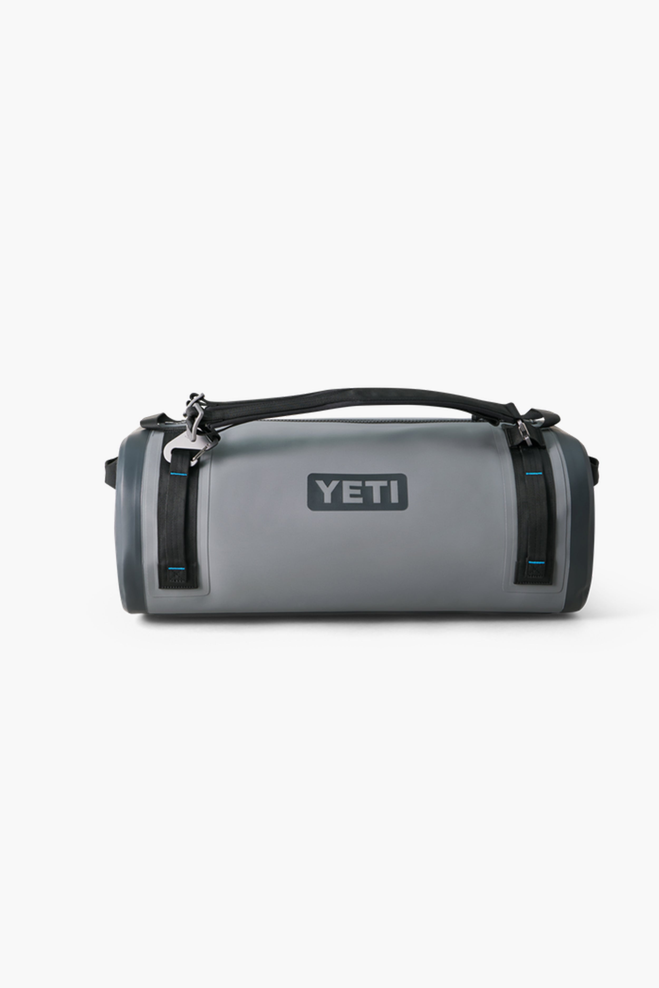 A durable gray YETI waterproof duffel with black straps and a top handle, ideal for outdoor adventures as a reliable gear bag.