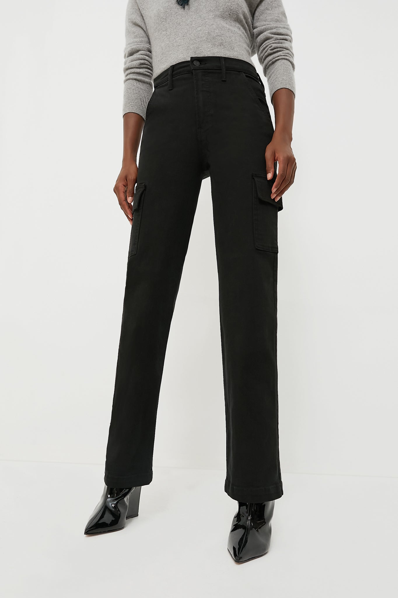 Someone wears a grey sweater, MOTHER high rise wide leg cargo jeans in soft stretch denim with side pockets, and black pointed-toe ankle boots.