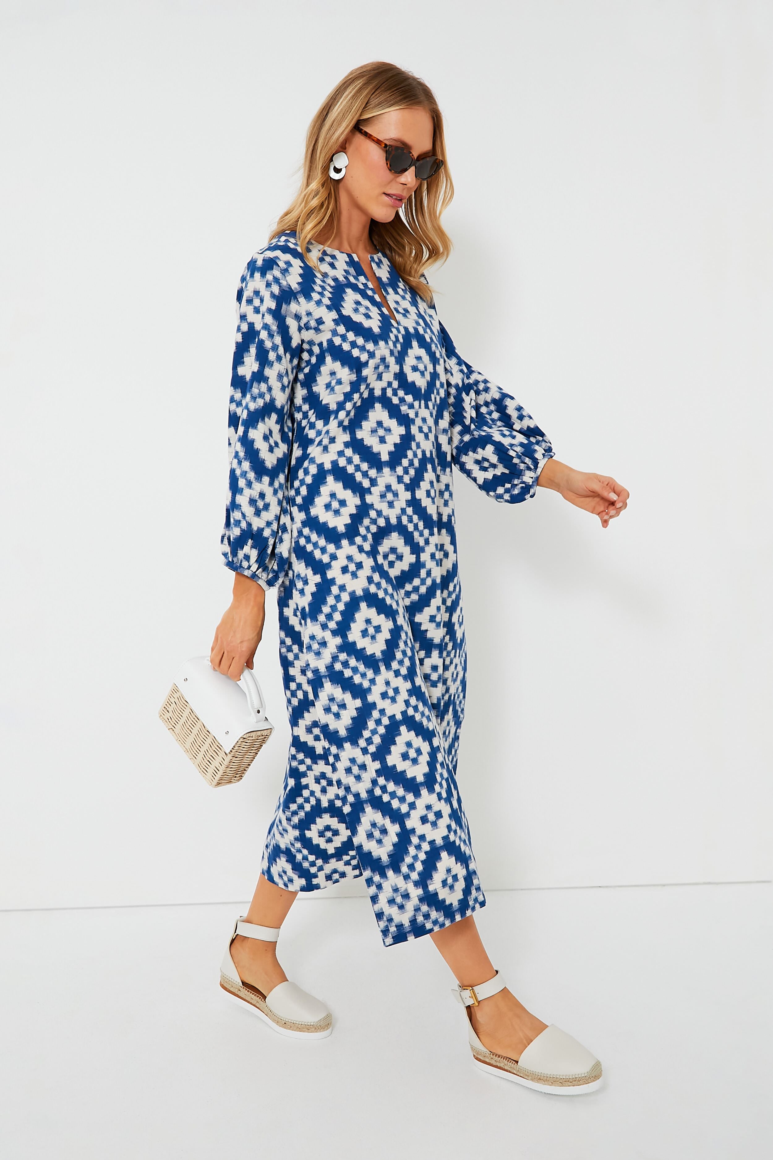 A woman wears the KLEED Blue Dorcas Kaftan in IKAT cotton, paired with sunglasses, white earrings, beige espadrille sandals, and a small white handbag—a sustainable loungewear look that’s effortlessly chic.