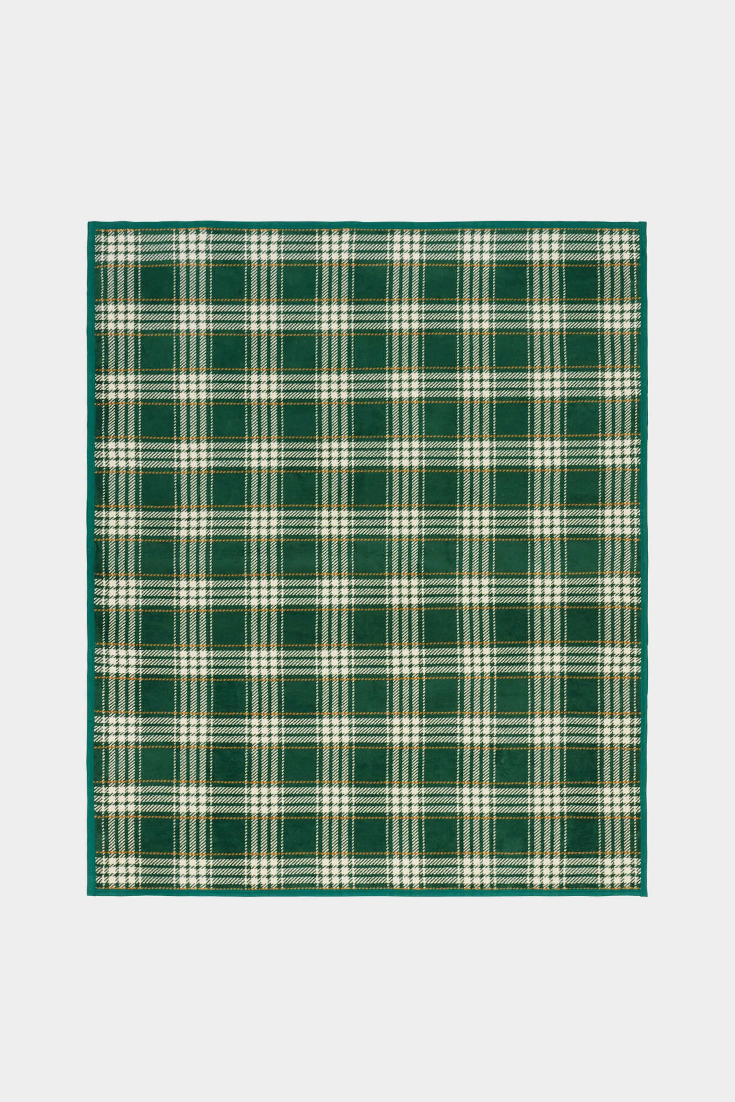 A rectangular mat by ChappyWrap featuring a green and white plaid pattern inspired by their cozy blanket style.