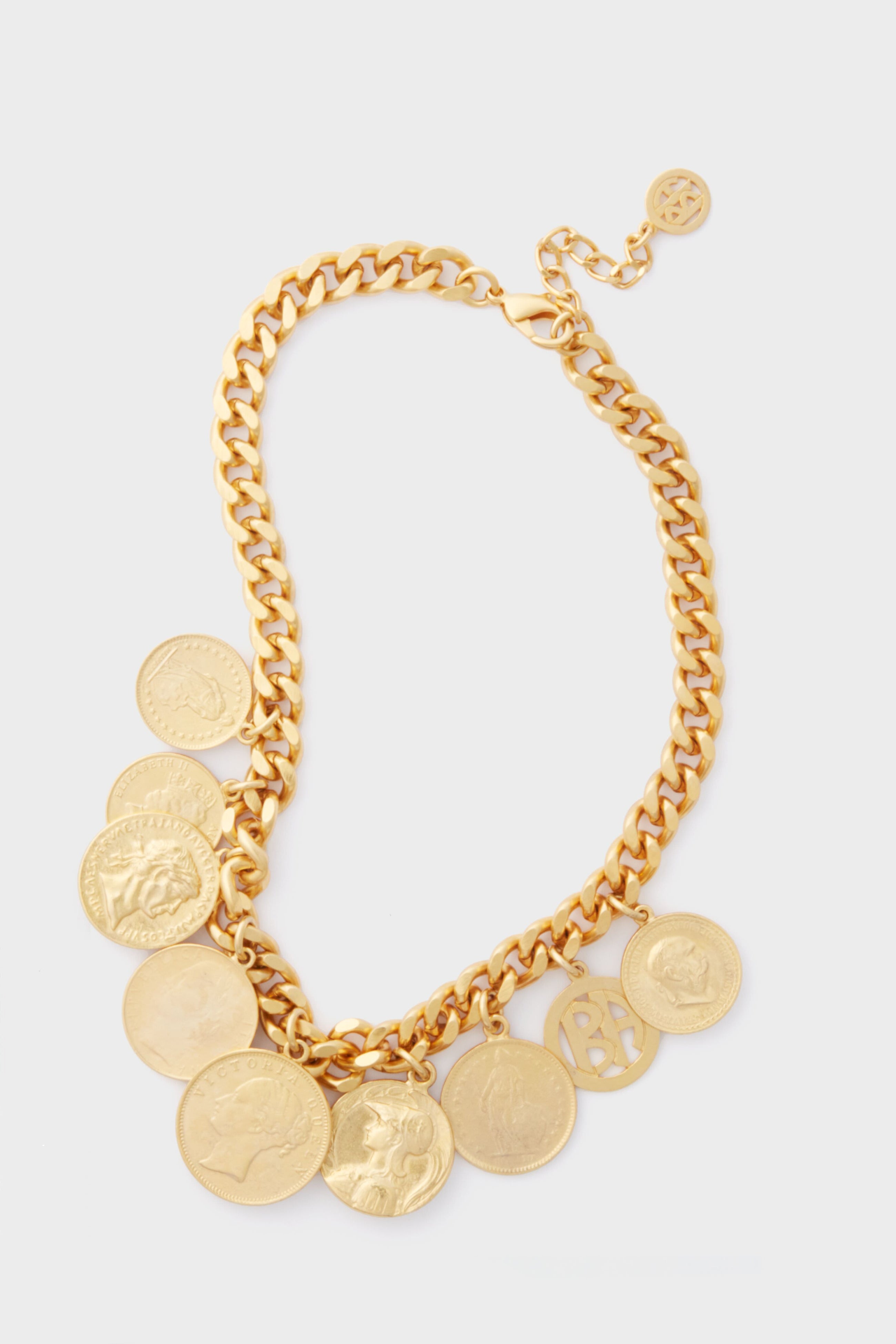 A Ben Amun 24K gold-plated necklace featuring multiple round coin pendants with assorted designs, displayed on a plain surface.