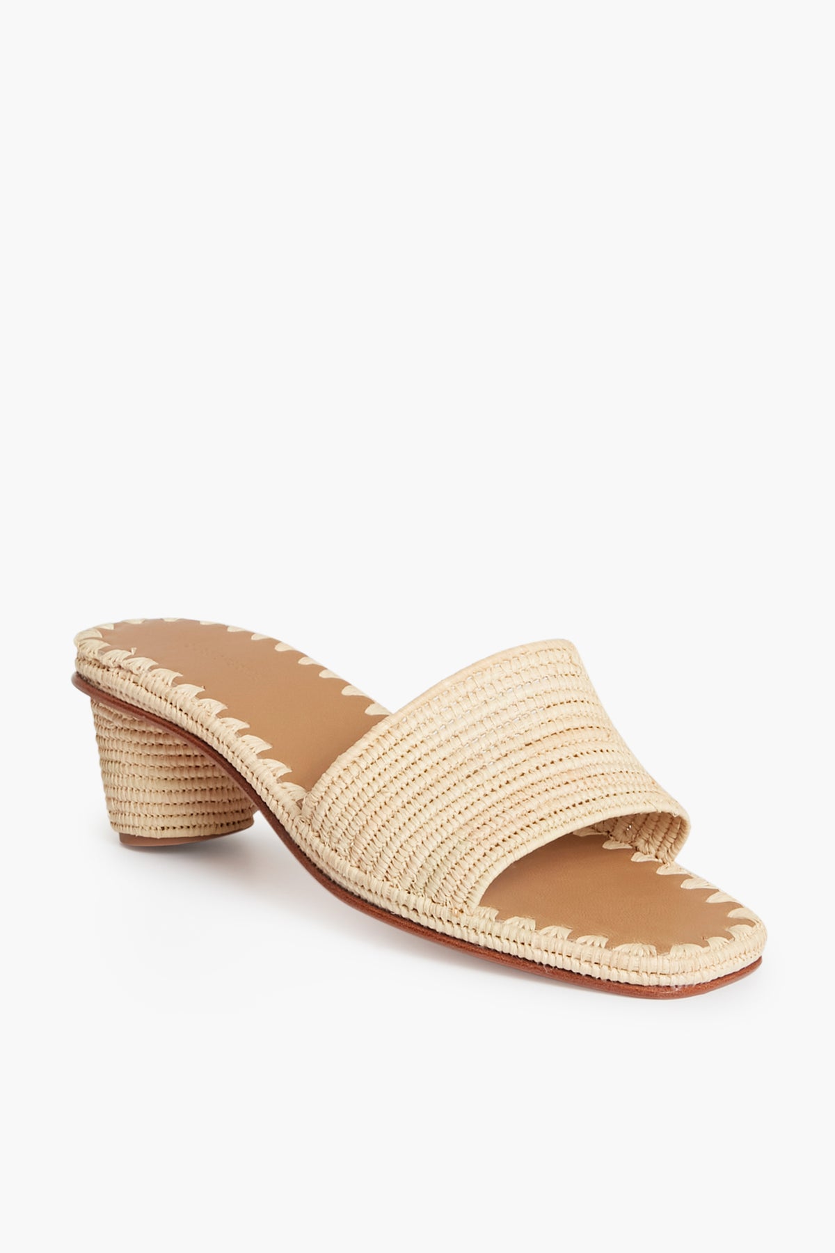 The Carrie Forbes beige woven heeled sandal, handmade in Morocco, features an open toe, low block heel, and a single wide strap across the front.