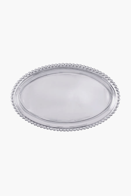 The Mariposa polished oval platter, crafted from recycled aluminum with a pearl beaded border, offers timeless elegance.