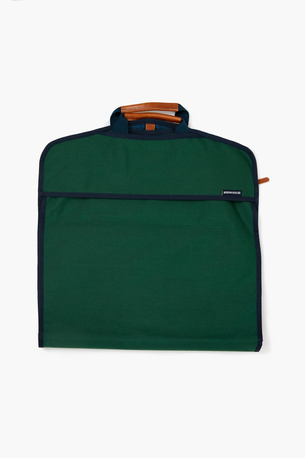 The Hudson Sutler green fabric garment bag features black trim, a brown leather handle, and a zipper closure—a travel essential perfect for customizable bags.