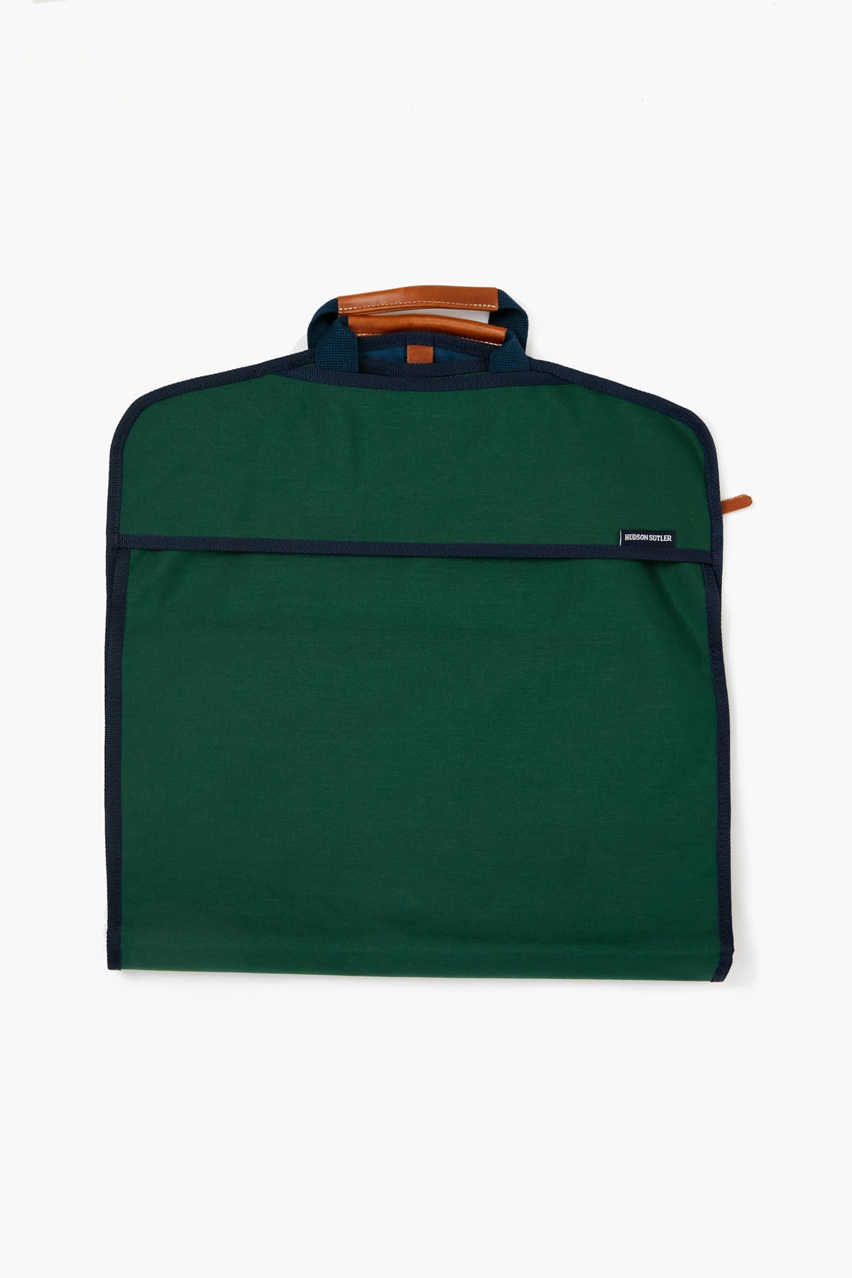The Hudson Sutler green fabric garment bag features black trim, a brown leather handle, and a zipper closure—a travel essential perfect for customizable bags.