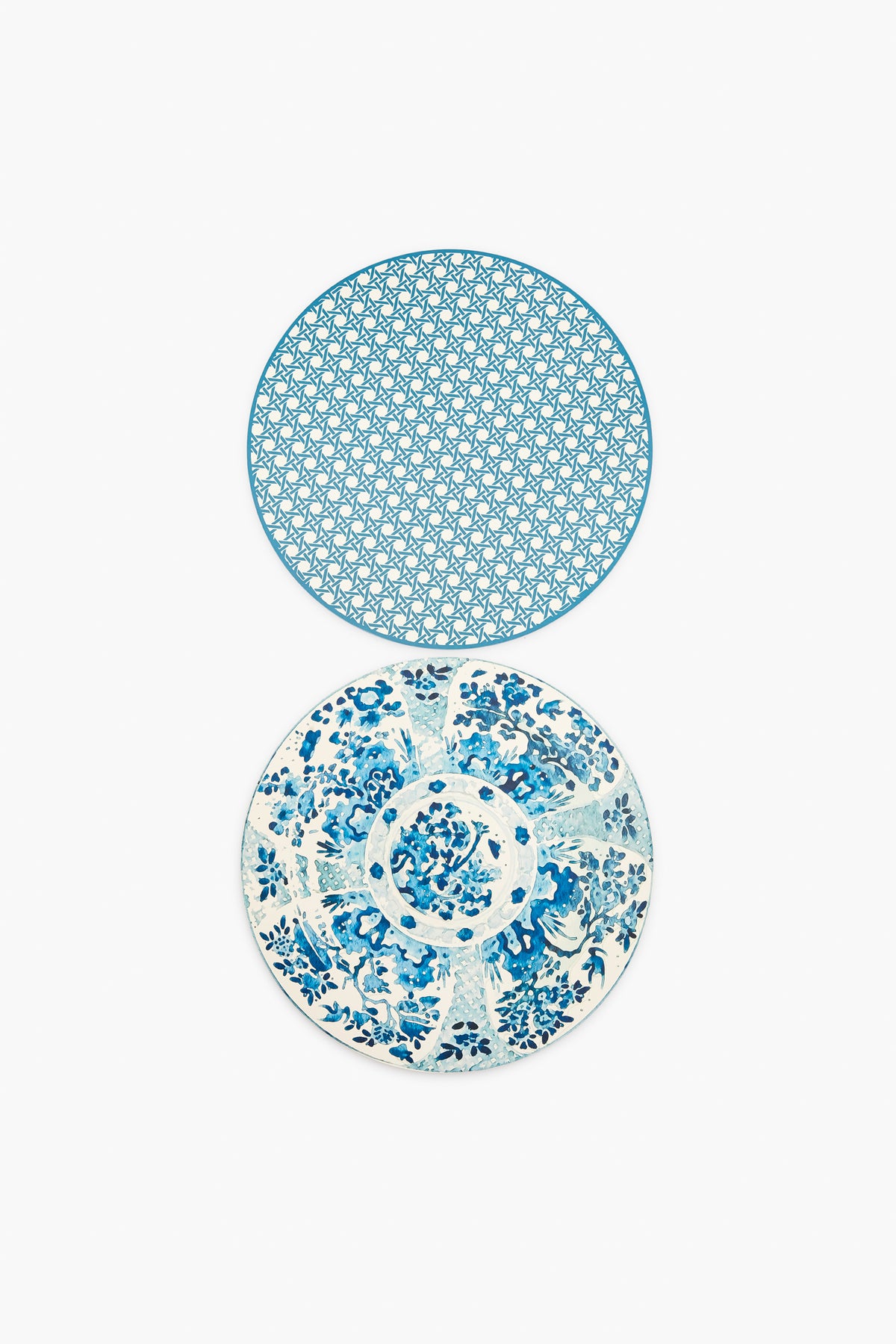 Two round plates from Holly Stuart Home with blue and white designs—the top has a geometric pattern, the bottom a floral motif—ideal as inspiration for handcrafted placemats or as a thoughtful hostess gift.