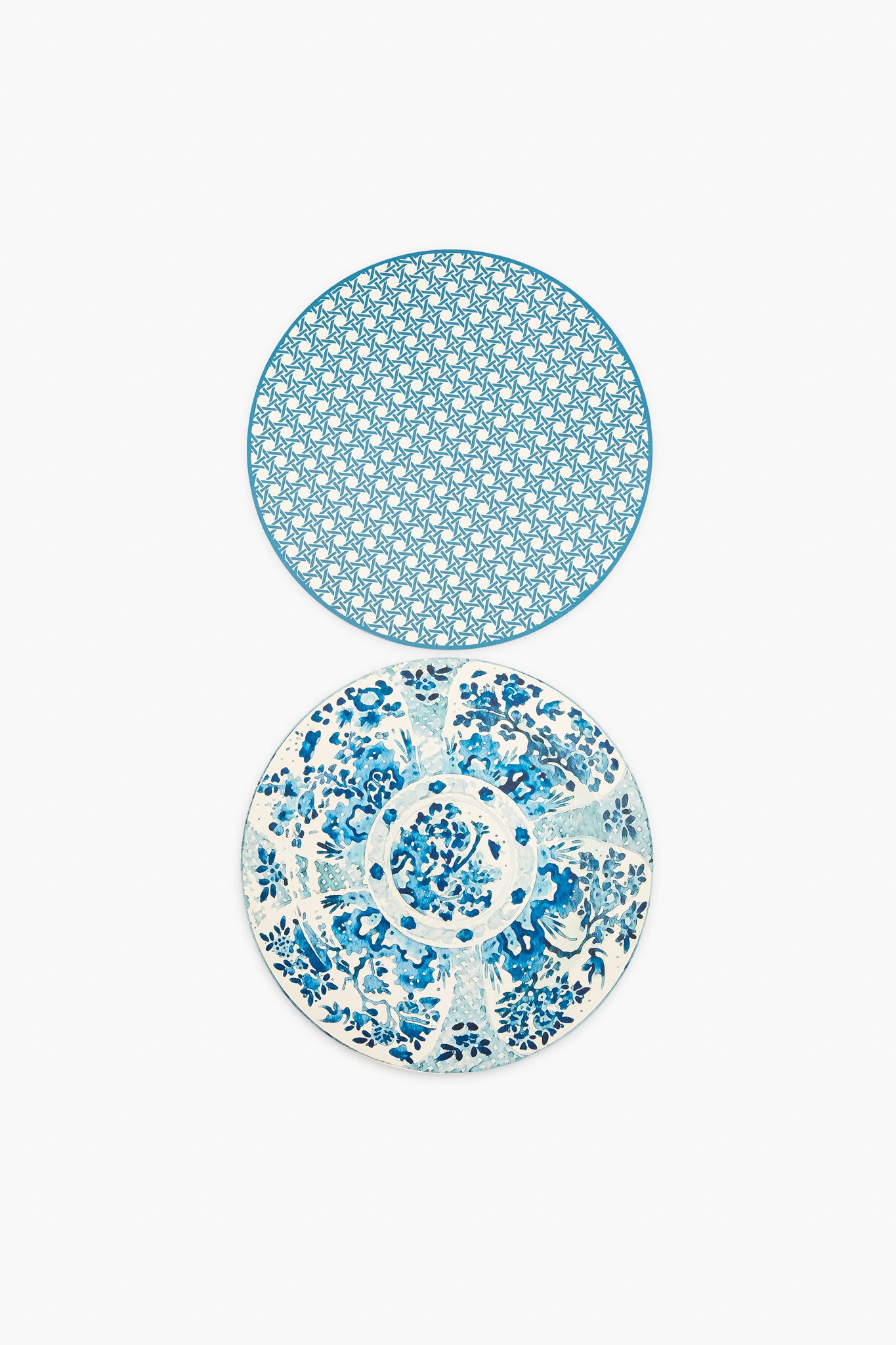 Two round plates from Holly Stuart Home with blue and white designs—the top has a geometric pattern, the bottom a floral motif—ideal as inspiration for handcrafted placemats or as a thoughtful hostess gift.