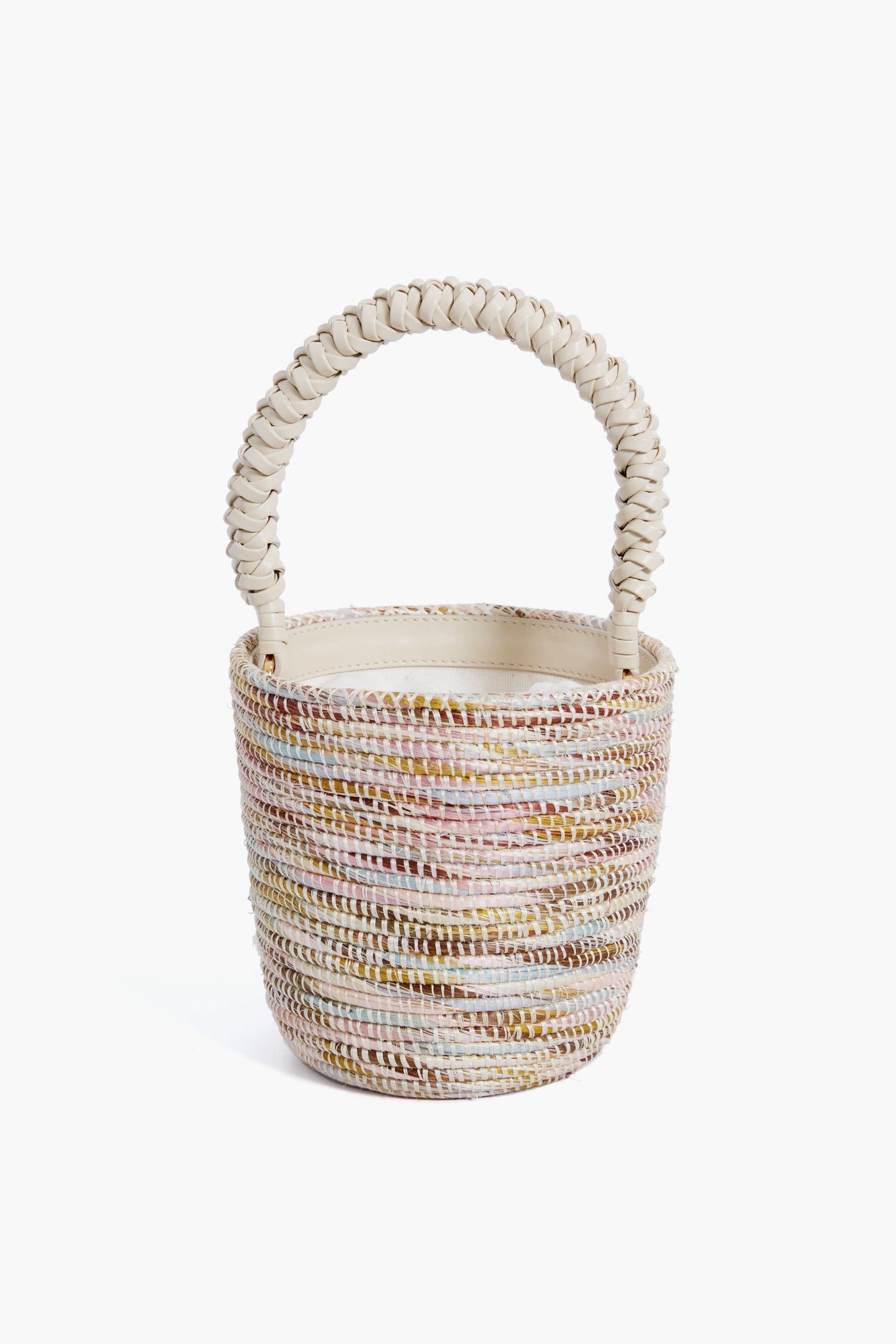Cesta Collective’s handwoven basket bag features pastel stripes and a thick braided handle, sustainably crafted by skilled female artisans.