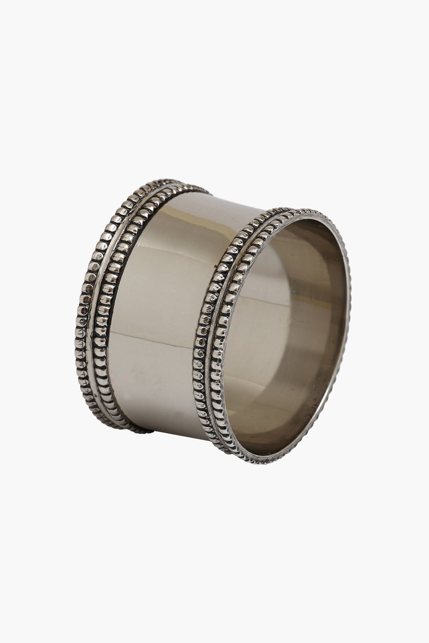 A Caton's Wharf silver band napkin ring features a smooth center and beaded edges, ideal for adding a classic accent to monogrammed home decor.