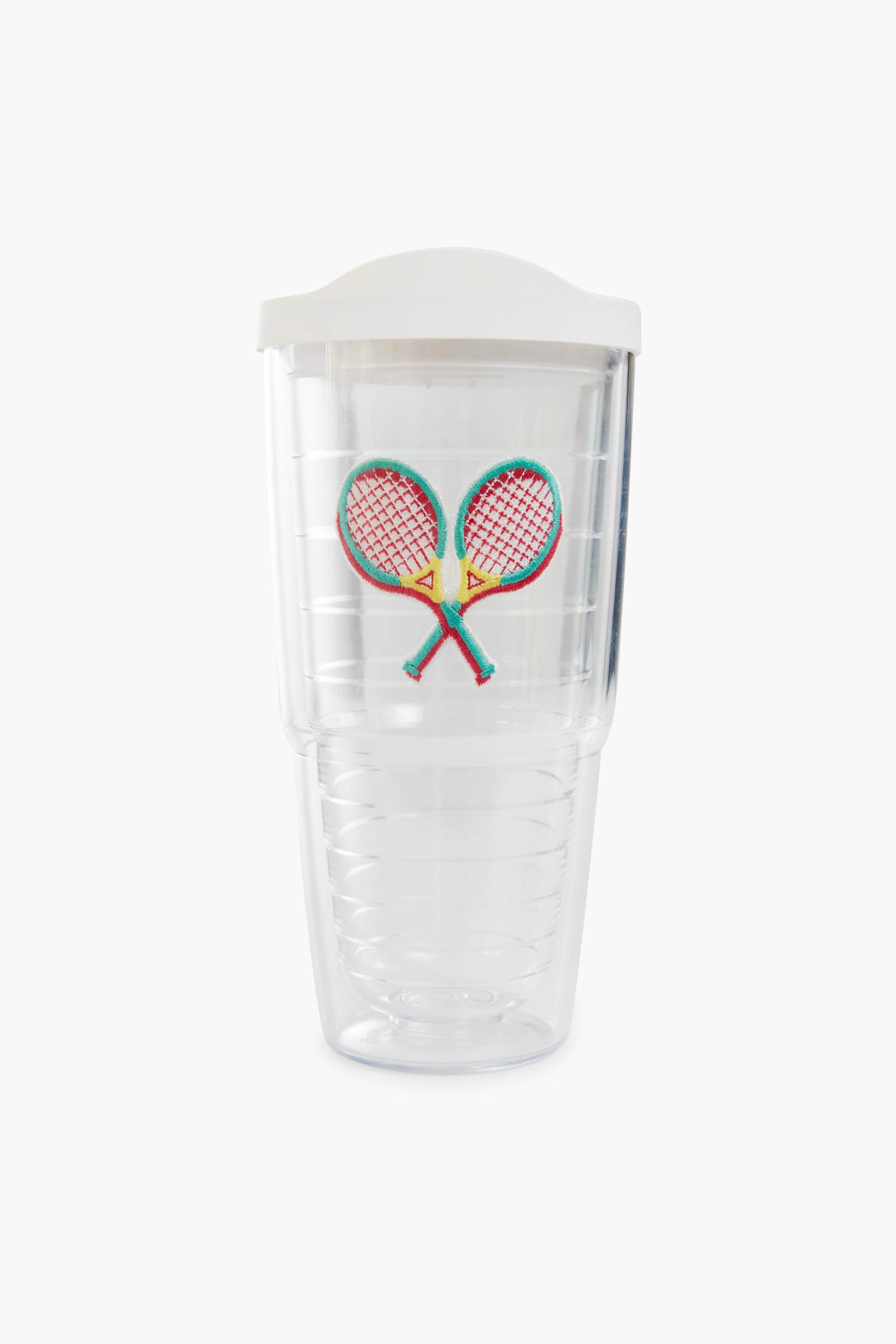 The Tervis Tumbler x Tuckernuck features a clear plastic body, white lid, embroidered crossed tennis rackets patch, double-wall design, and is BPA free.