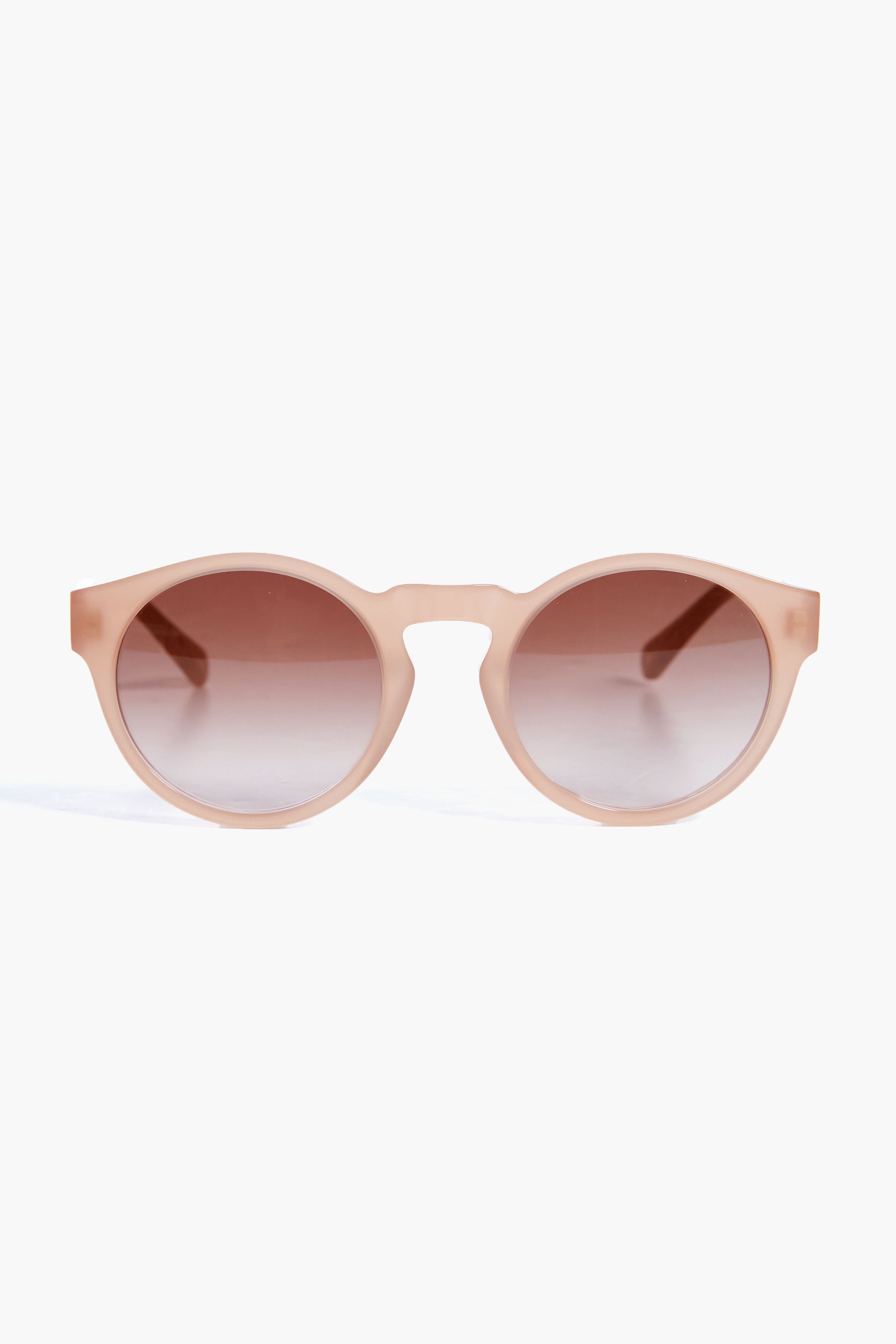 Chloe beige round-frame sunglasses with brown gradient lenses are elegantly displayed.