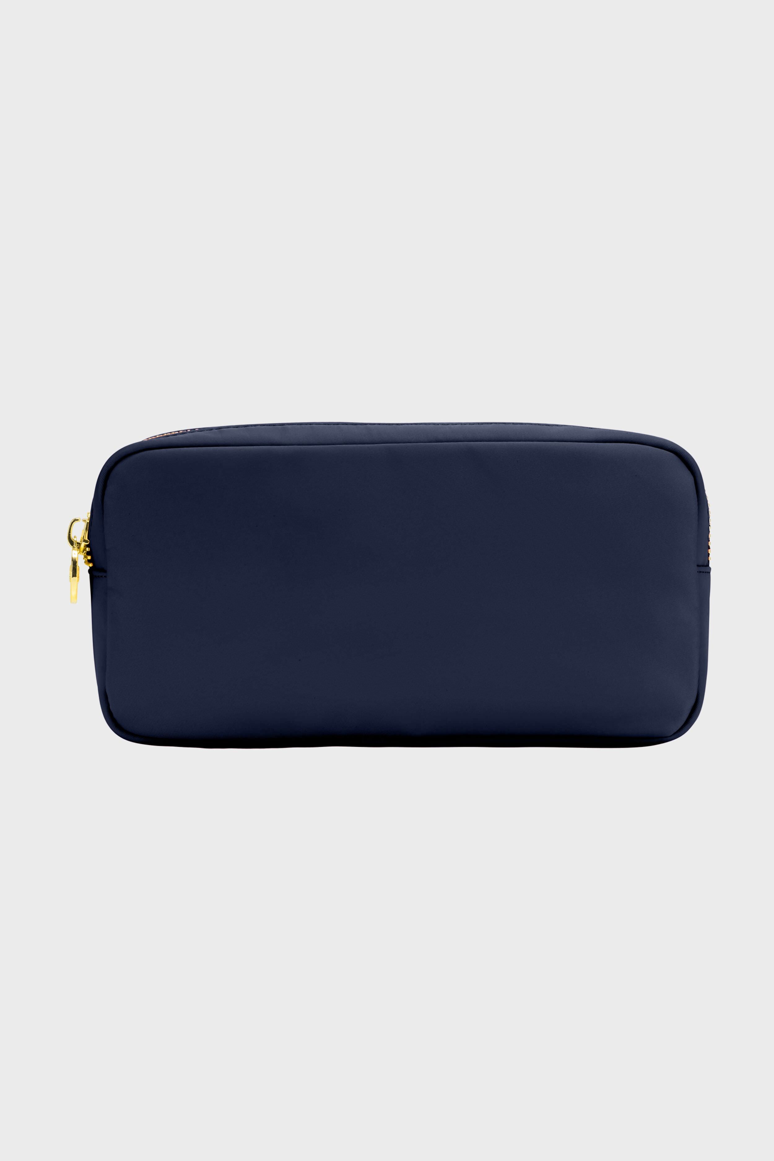 The Stoney Clover Lane rectangular navy blue zippered makeup bag features a gold zipper, making it perfect for travel accessories.