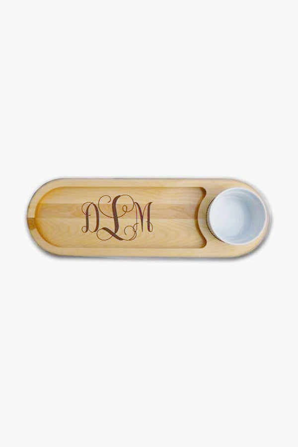A Carved Solutions wooden Dip & Serve Board with engraved DLM monogram and a circular slot for a white bowl—ideal as a housewarming gift.