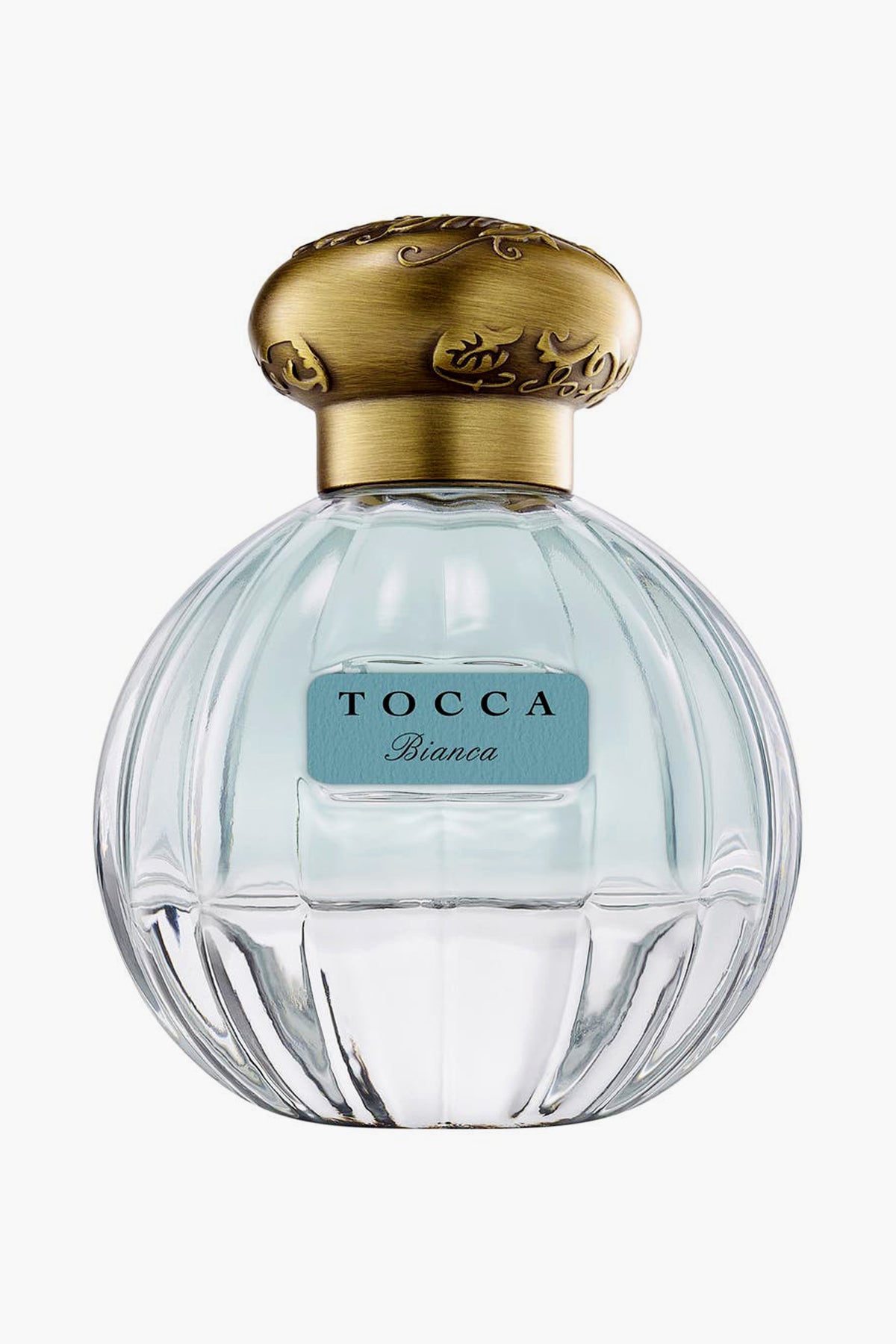 A clear glass bottle of Tocca Bianca perfume with a gold cap and blue label, offering a fresh floral scent accented by hints of green tea.