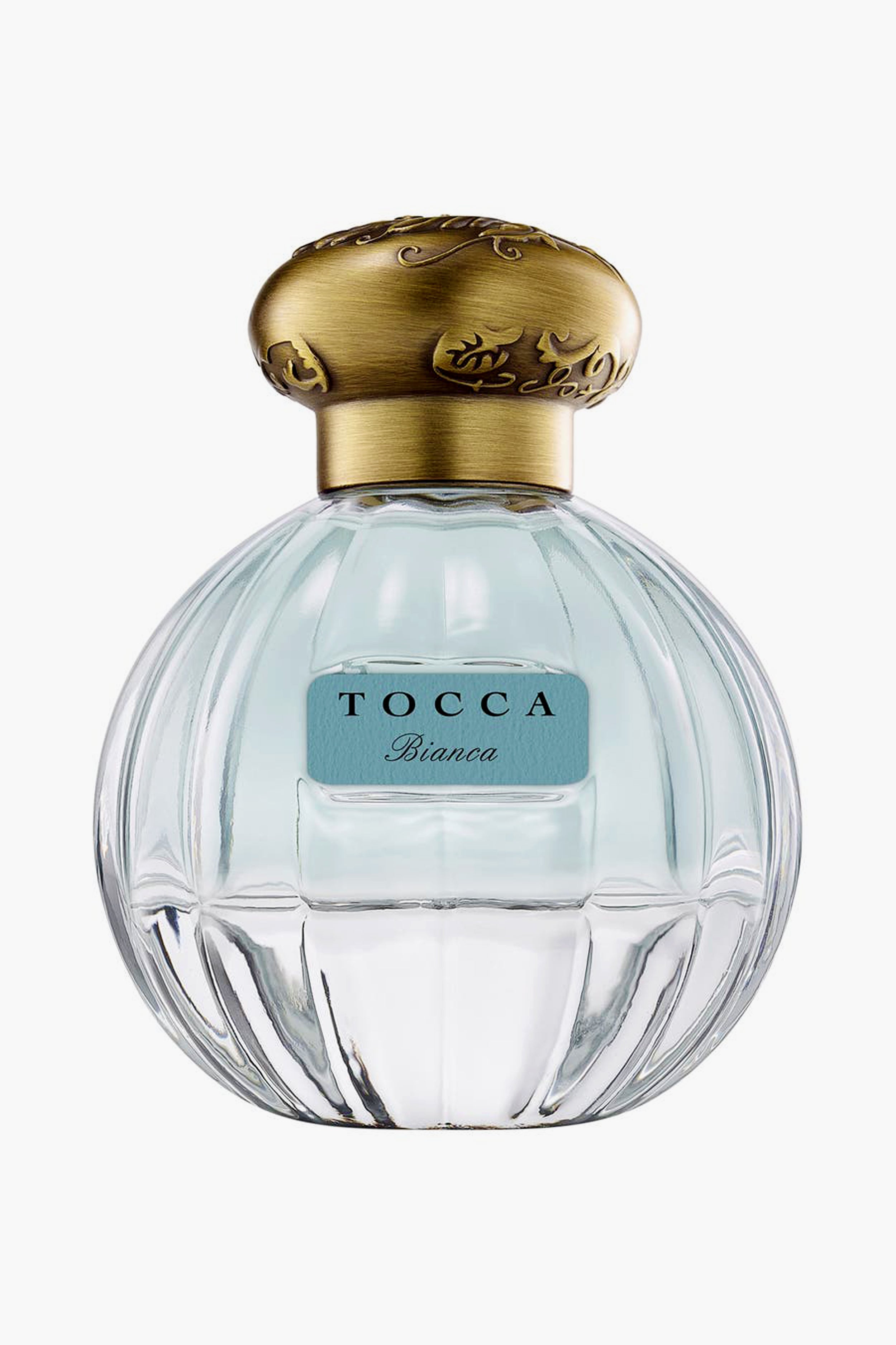 A clear glass bottle of Tocca Bianca perfume with a gold cap and blue label, offering a fresh floral scent accented by hints of green tea.