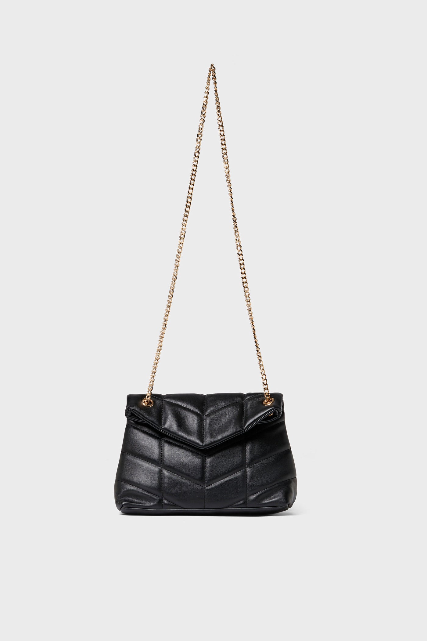 Urban Expressions black quilted crossbody bag made from vegan leather with a gold chain strap, elegantly displayed.