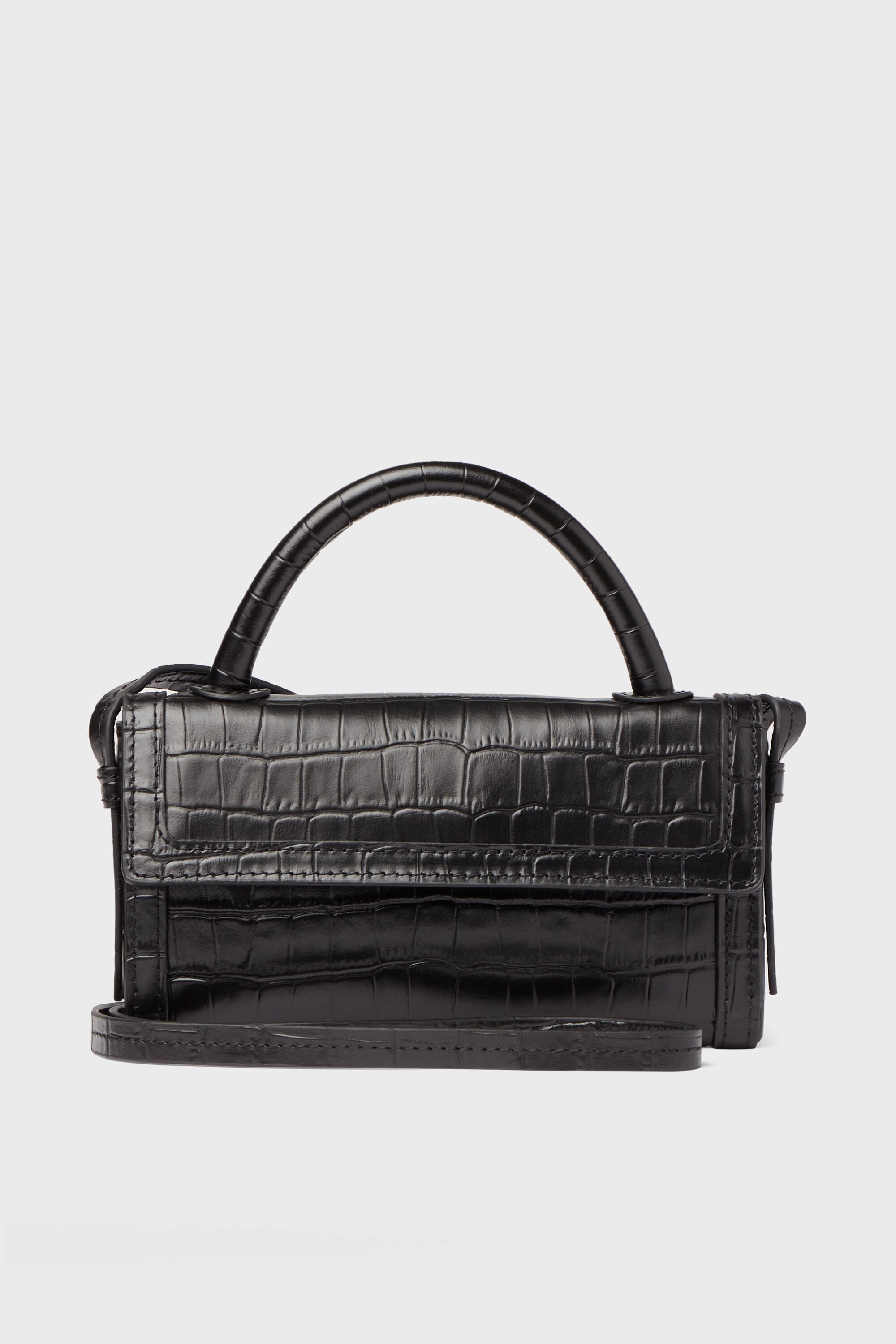 The Neely & Chloe Black Croc Phone Crossbody is a compact black handbag in croc-embossed leather, featuring a top handle and long shoulder strap—ideal for carrying your essentials in style.