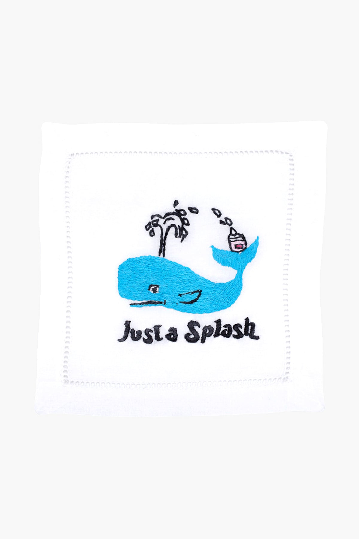 The August Morgan white cloth napkin features an embroidered blue whale, water spout, cocktail, and "Just a Splash" text—ideal as cocktail party decor or a charming hostess gift.