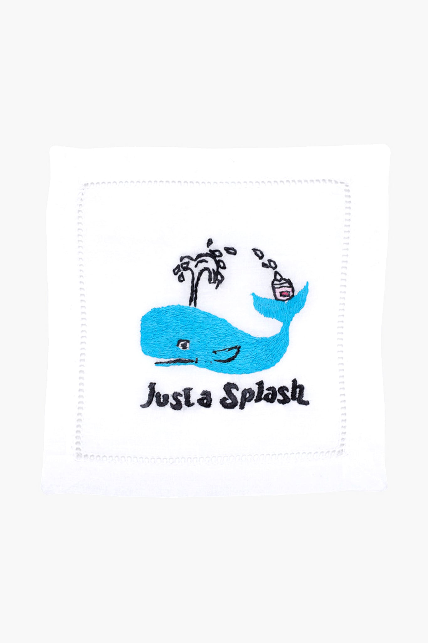 The August Morgan white cloth napkin features an embroidered blue whale, water spout, cocktail, and "Just a Splash" text—ideal as cocktail party decor or a charming hostess gift.