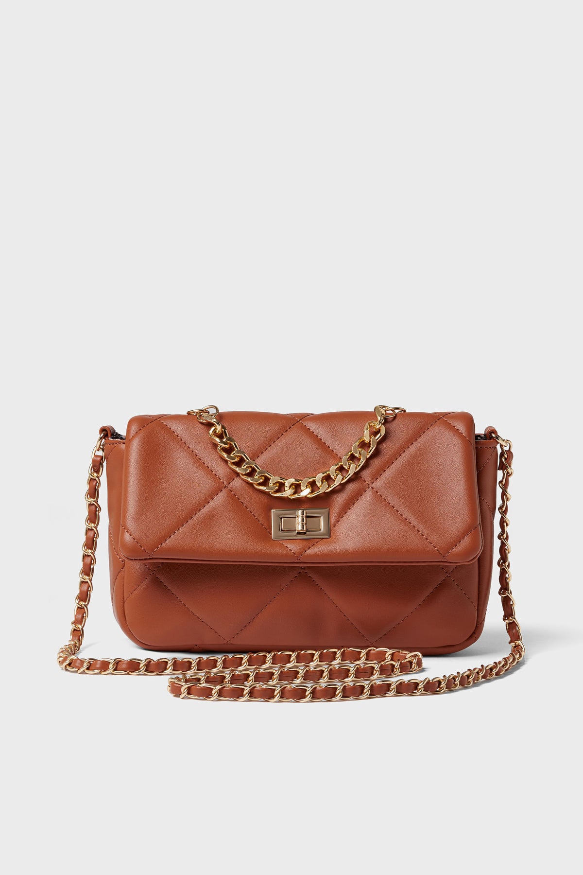 Urban Expressions brown quilted crossbody bag features a gold chain strap and clasp, crafted from animal-friendly vegan leather.