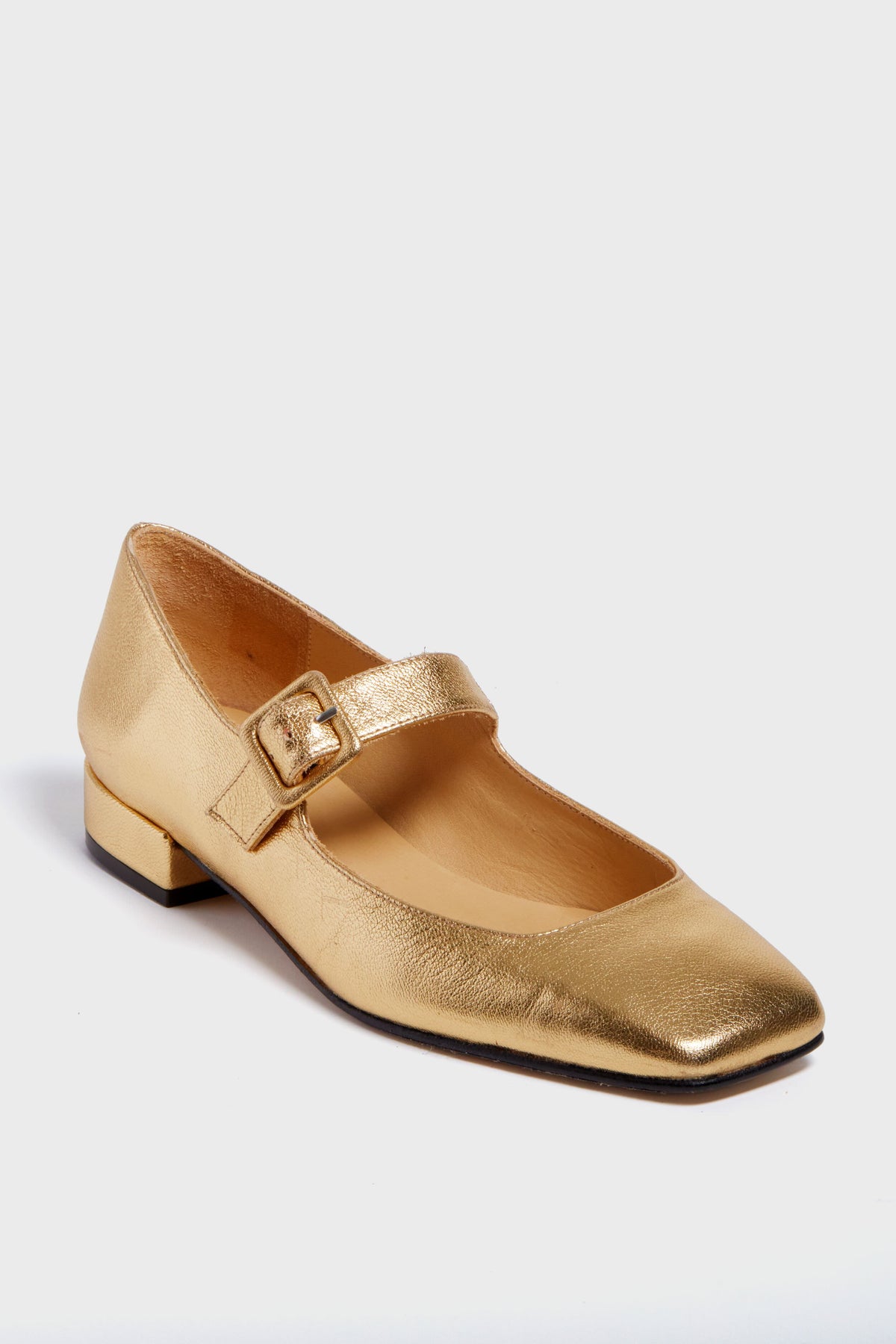 A gold metallic leather Mary Jane flat by Penelope Chilvers, featuring a low square heel and buckle strap.